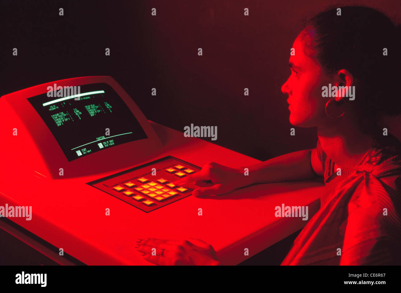 Woman working on computer in control room Stock Photo - Alamy