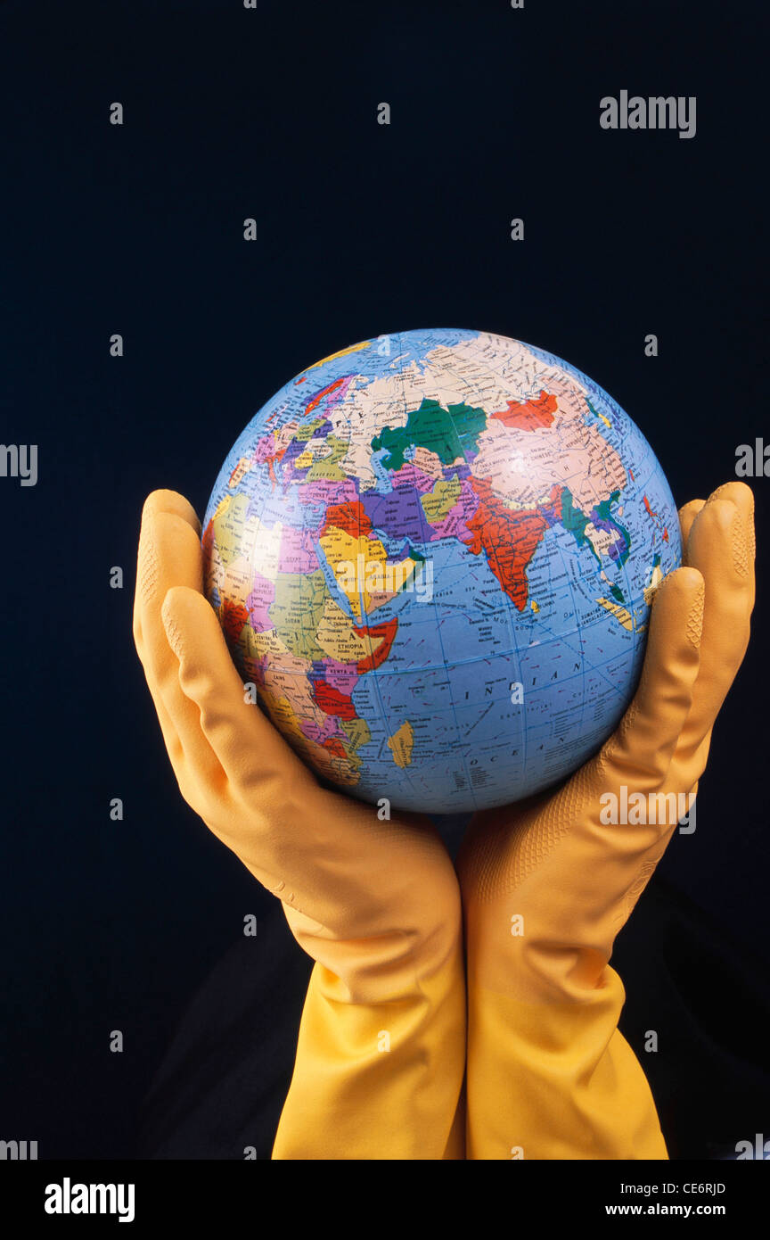 STP 85767 : man wearing rubber gloves holding world globe showing india indian ocean asia chine africa iran saudi arabia Stock Photo