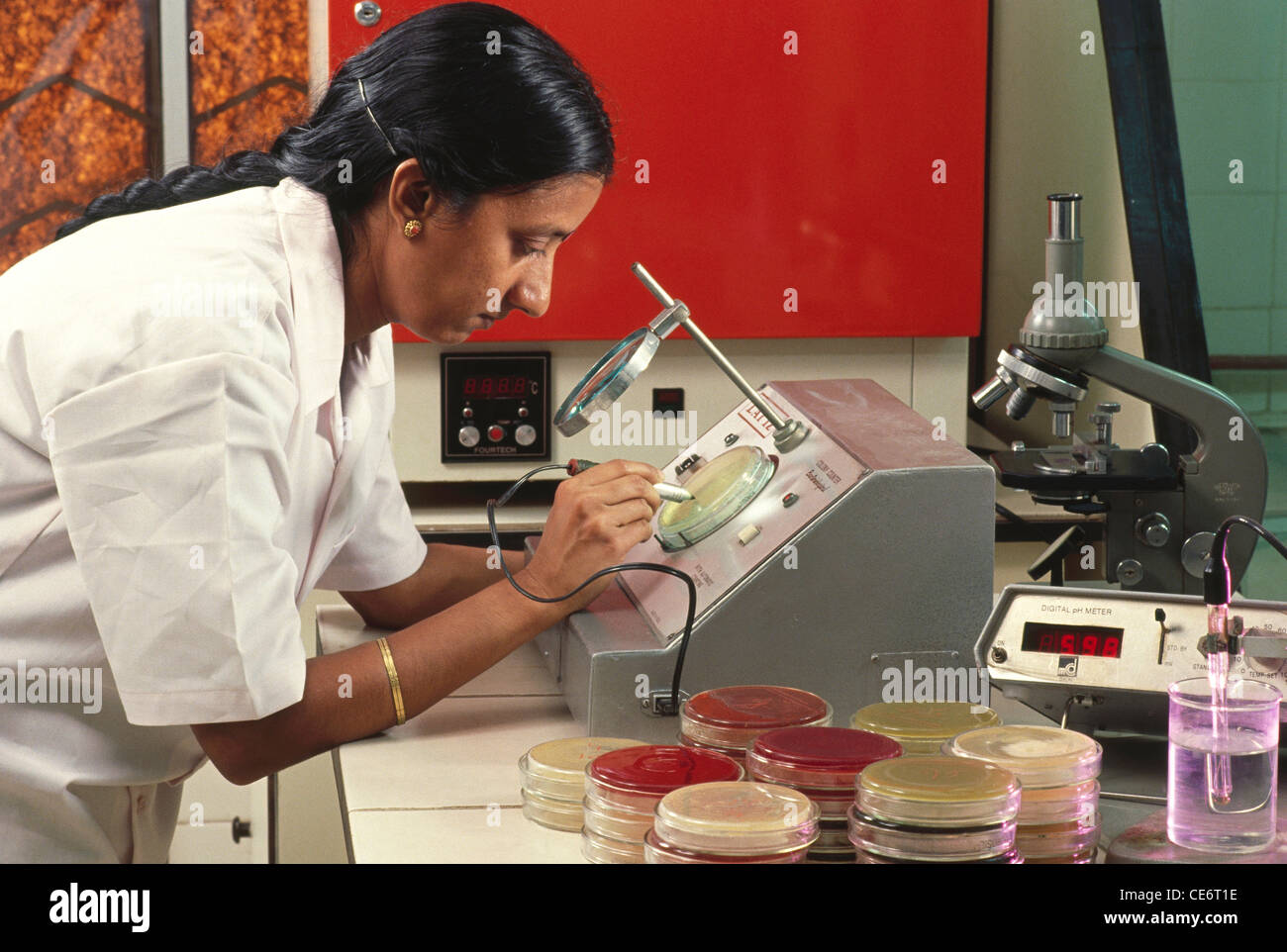 Hma Lab HMA 85880 : lab technician doing research using magnifying glass and ...