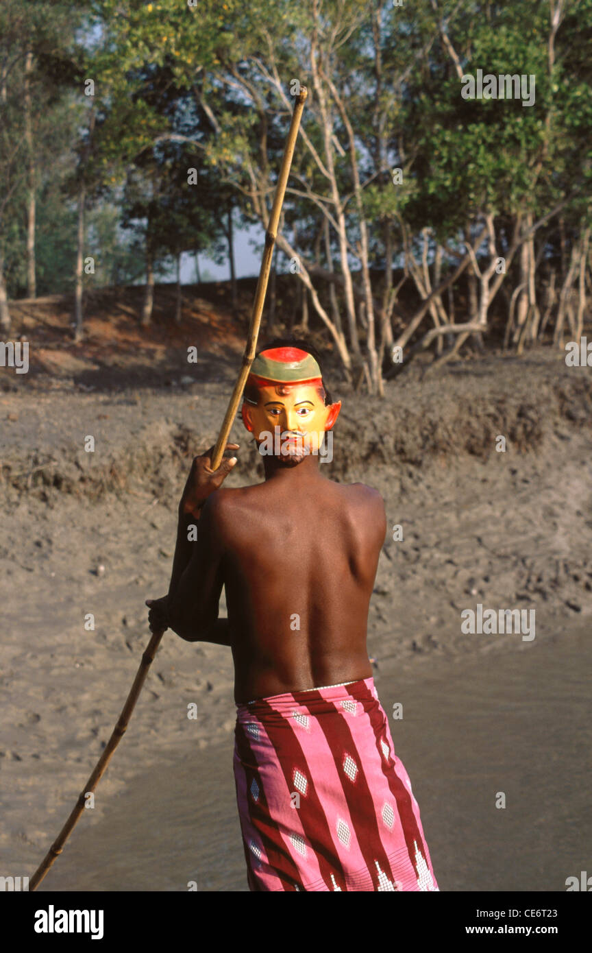 Man wearing mask behind the head to repel tiger attack; Sunderbans Wildlife Sanctuary; West Bengal; India; Asia Stock Photo