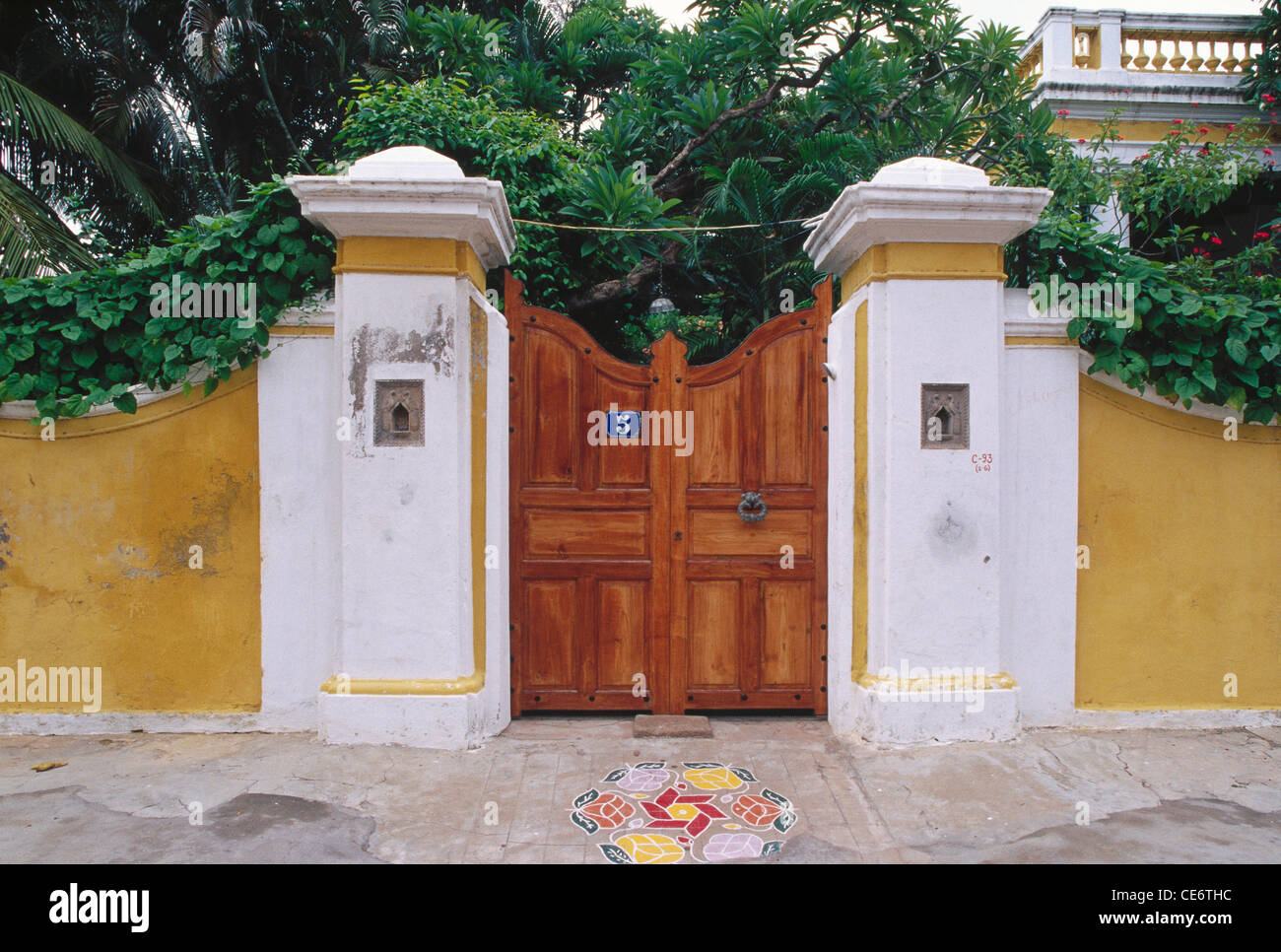 AAD 85164 closed wood door of old house with rangoli at entrance pondicherry union territory