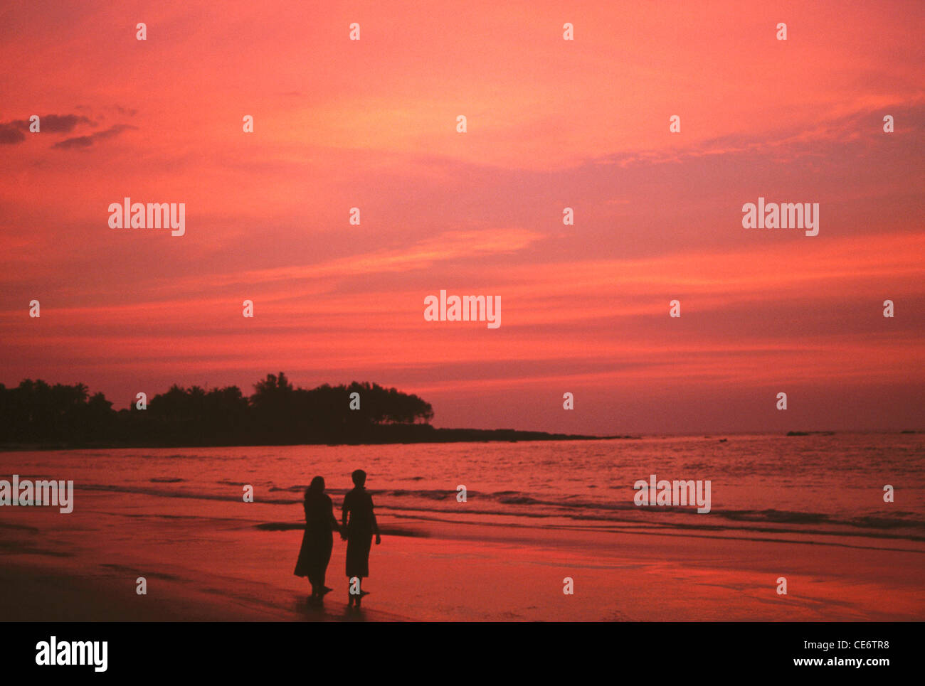 MMN 85985 : couple on beach at sunset dusk evening at chivla beach ...