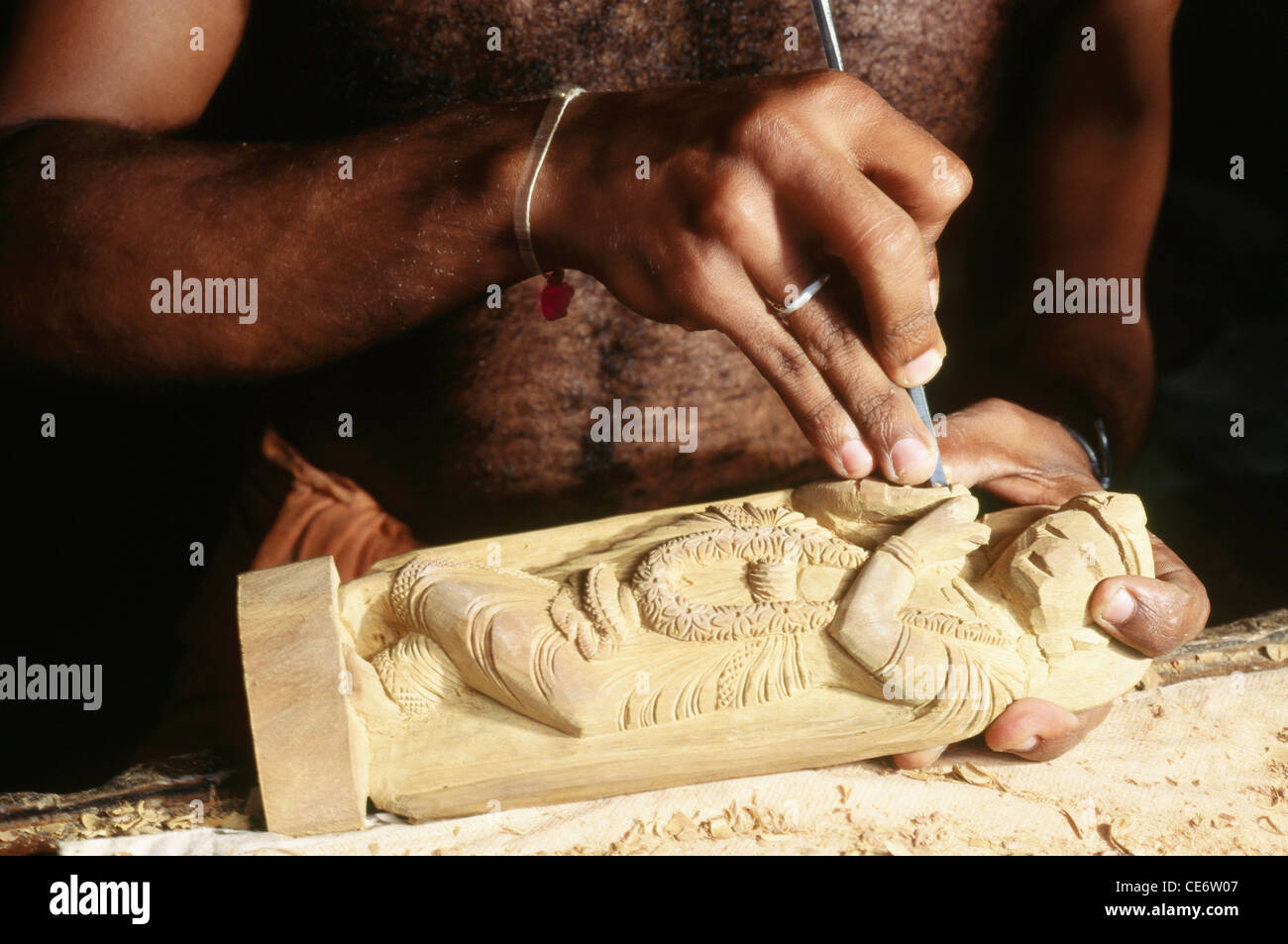 VDA 85120 : man carving making lord krishna sandalwood statue india Stock Photo