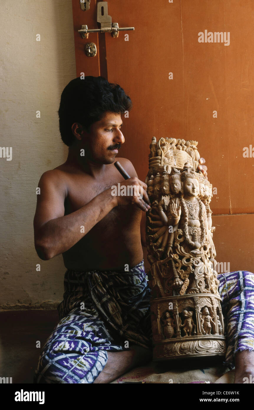 MAA 83289 : indian man carving buddha on sandal wood mysore karnataka india Stock Photo