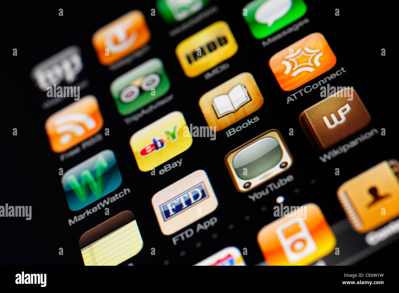 Muenster, Germany, January 26, 2012: Image of the iphone touch screen. Display shows a collection of useful apps with orange and Stock Photo