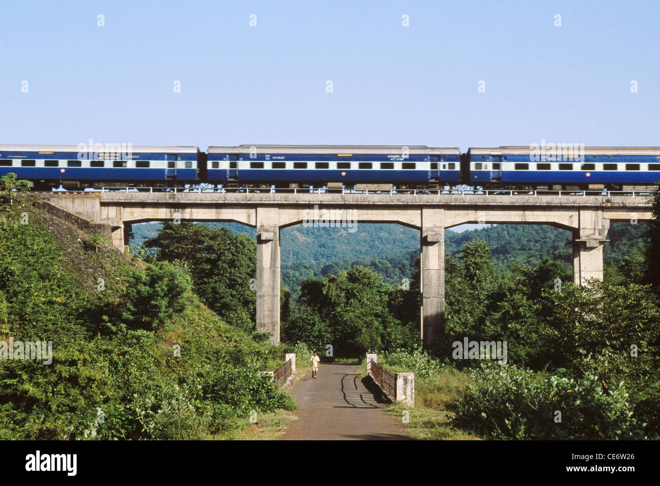 MMN 83264 konkan railway train on bridge above road at chiplun