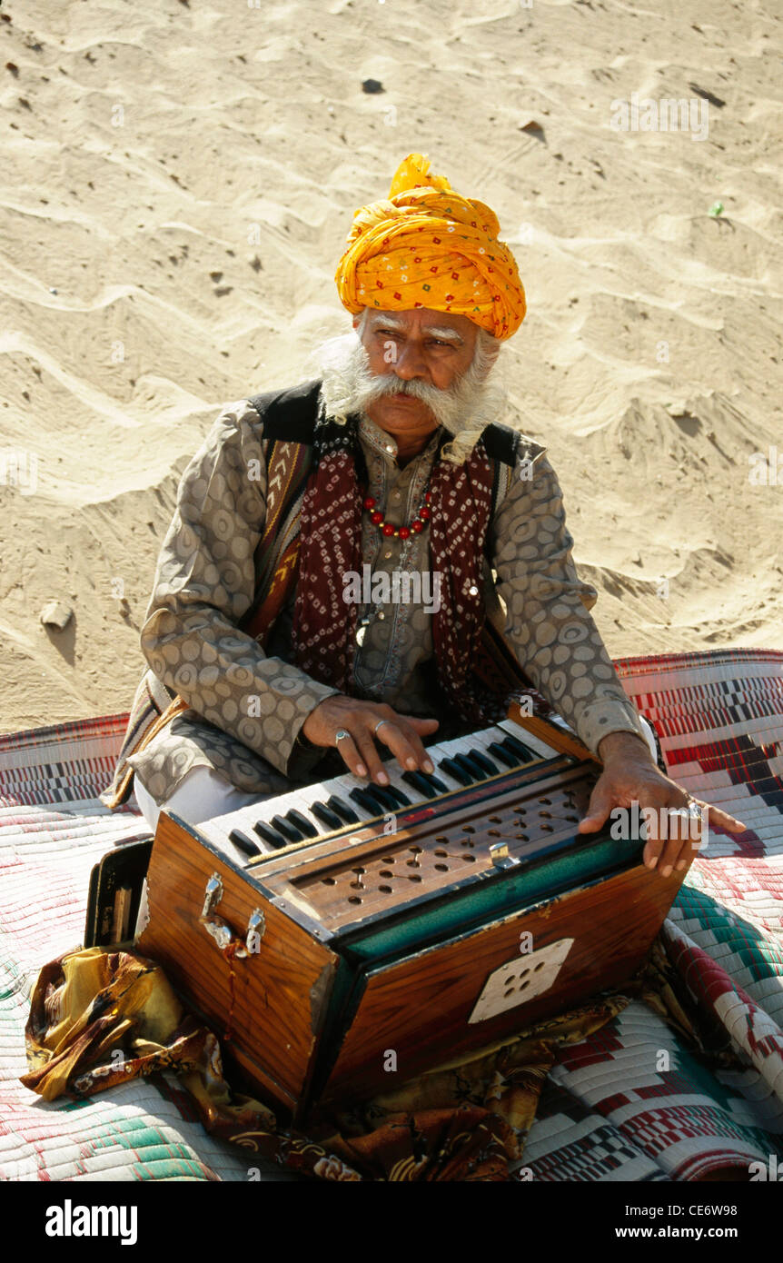 BDR 83350 : indian rajasthani old man folk musician playing musical instrument harmonium jaipur rajasthan india MR#657 Stock Photo