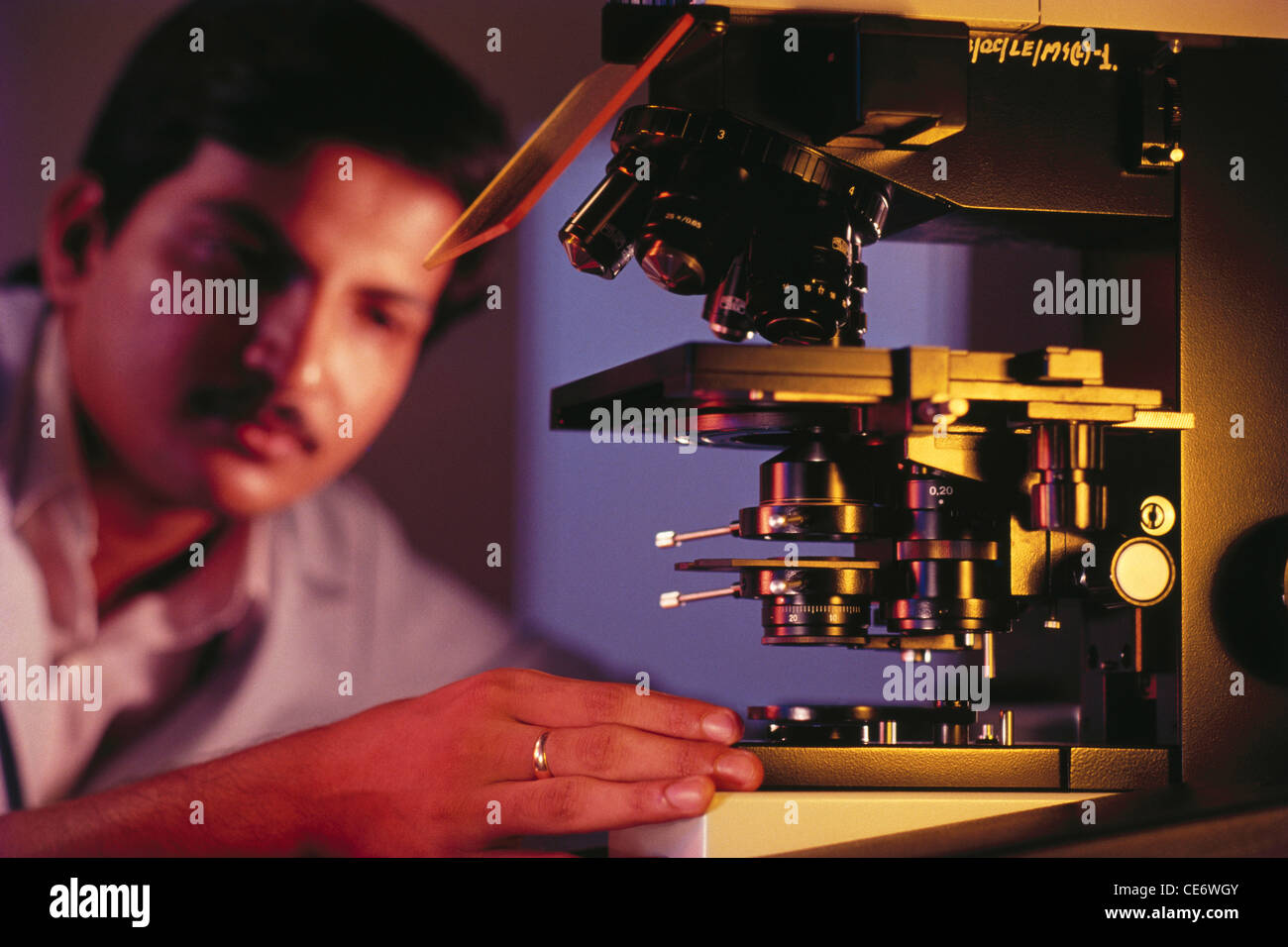 Man working on lab instruments india Stock Photo Alamy