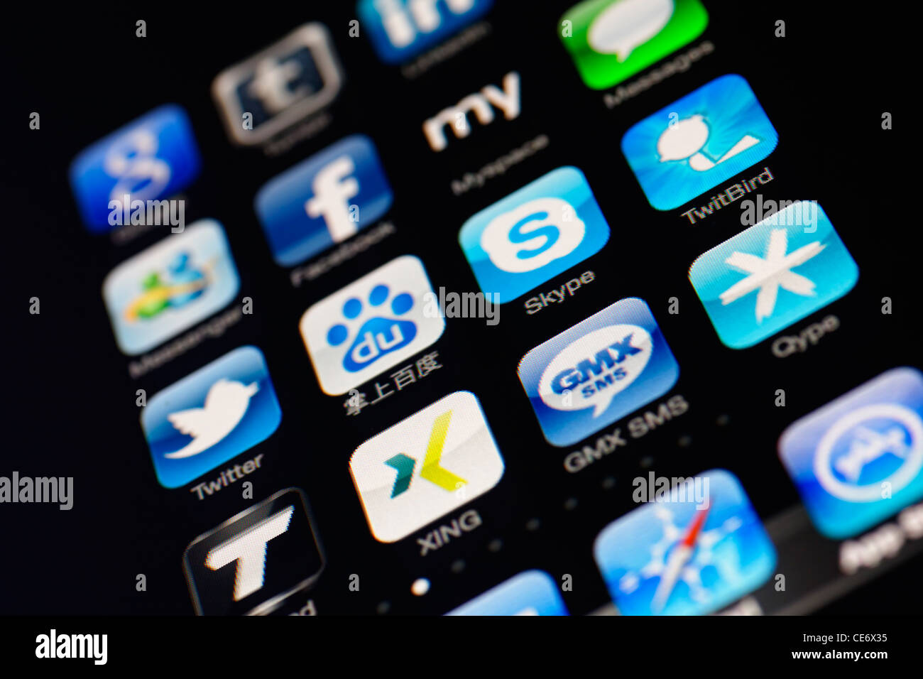 Muenster, Germany, January 26, 2012: Image of the iphone touch screen. Display shows a collection of useful apps with blue color Stock Photo