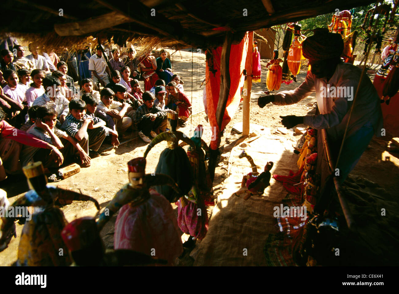 Puppet show ; puppeteer and audience ; children enjoying watching at udaipur ; rajasthan ; india ; asia Stock Photo