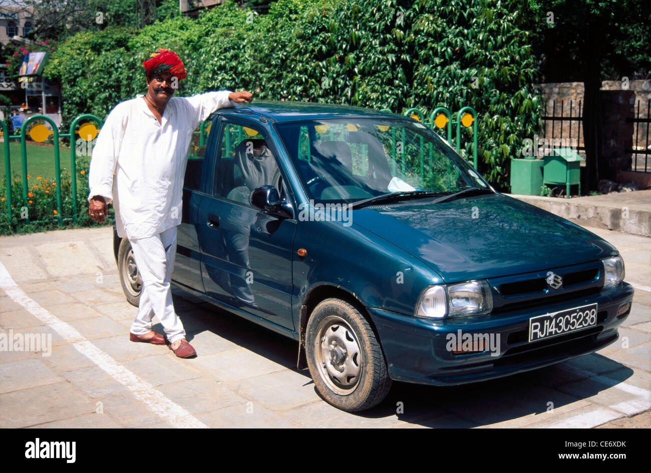 MMN 85473 : Indian rajasthani man standing with his zen car jaipur rajasthan india   Model Released Stock Photo