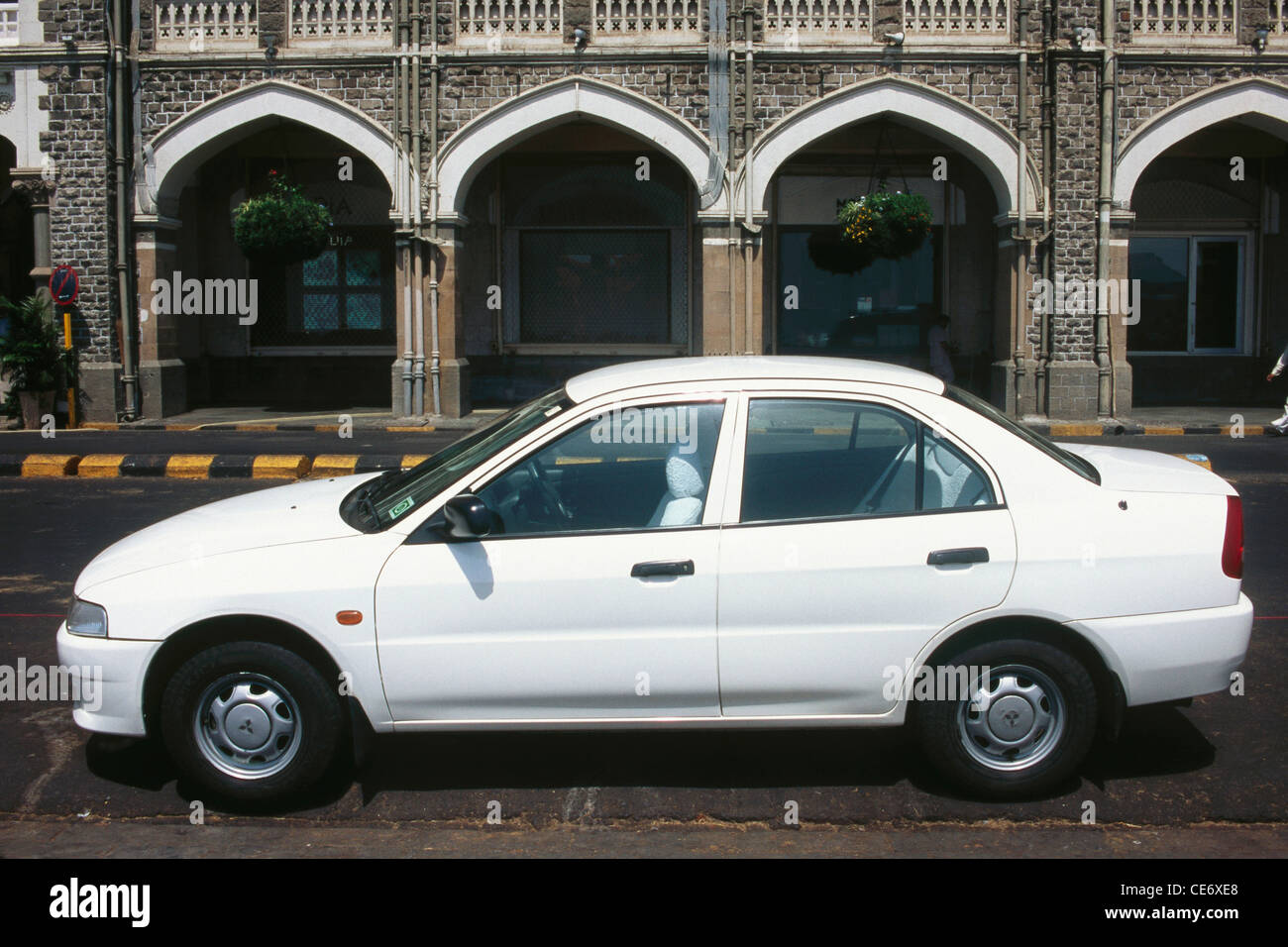 NMK 85469 : profile of mitsubishi lancer white car parked on the road below Taj Mahal Hotel bombay mumbai maharashtra india Stock Photo