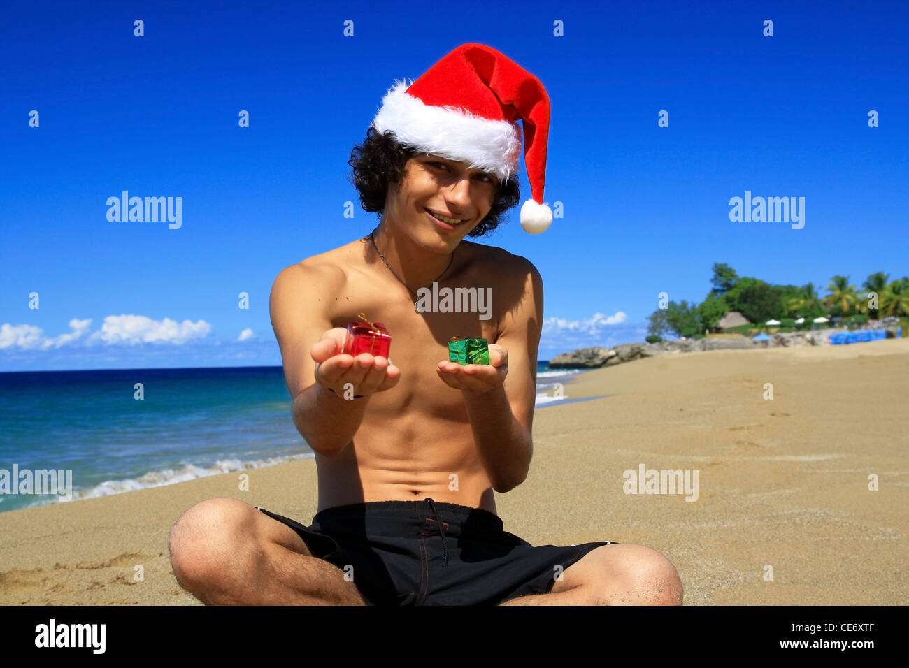 Santa Claus with gift boxes on beach of ocean Stock Photo - Alamy