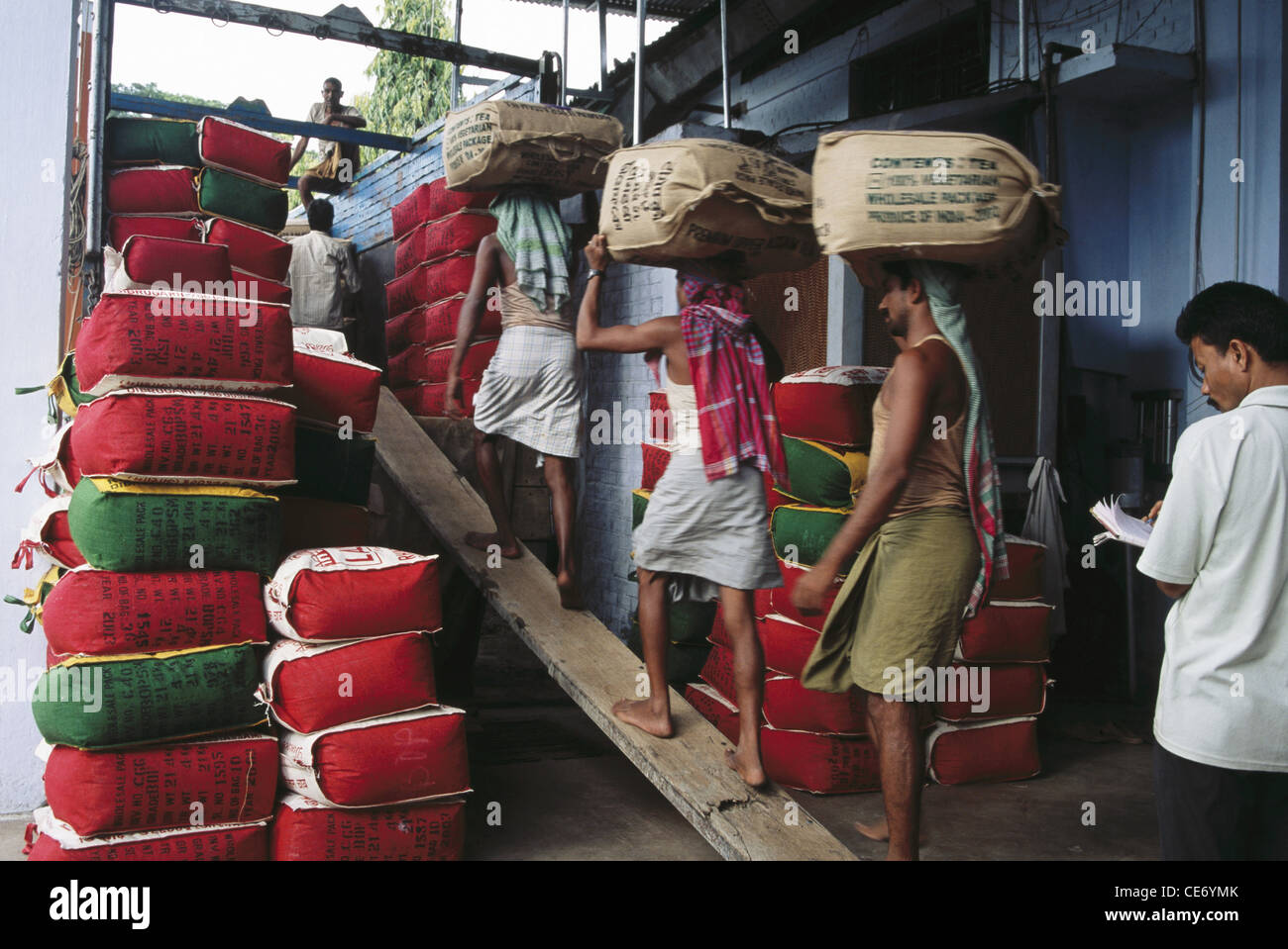 tea packed in jute sacks being loaded in truck for sale export distribution assam india Stock Photo