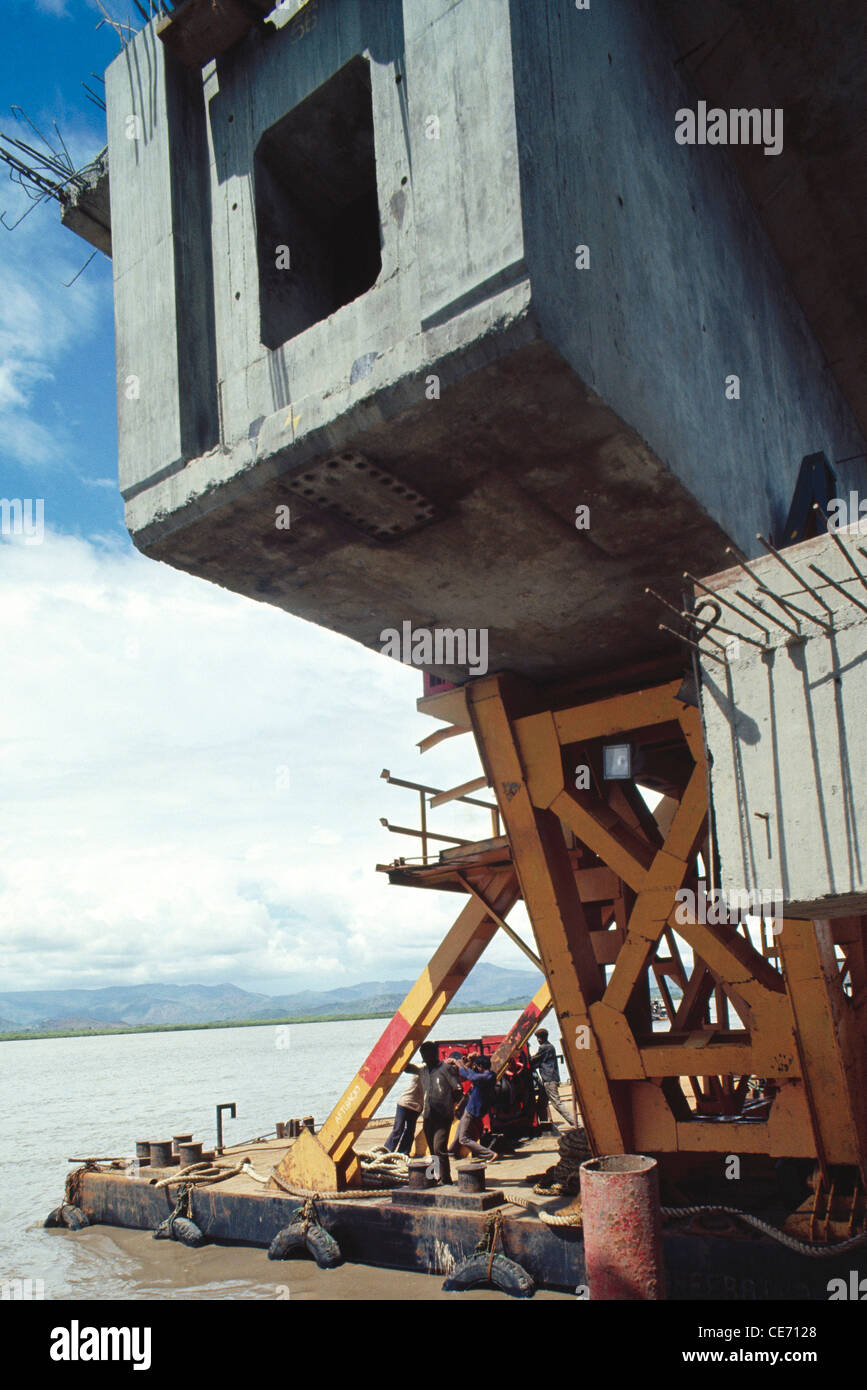 Construction work in progress of a bridge on a river india Stock Photo