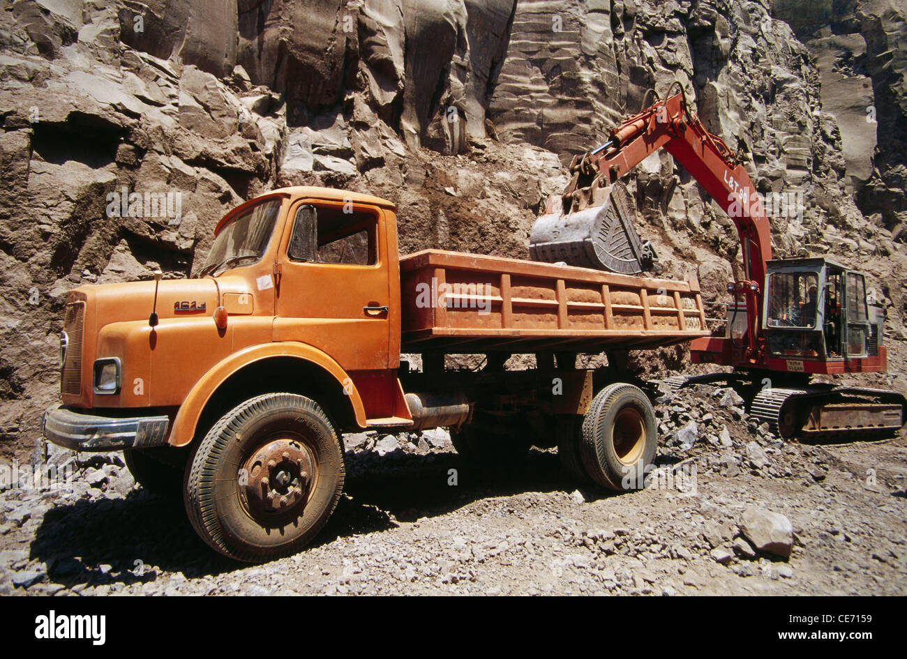 Excavator machine working ; earthmover loading stones rocks in truck ; Wang Dam ; Karad ; india ; asia Stock Photo