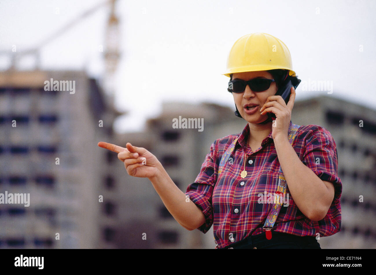 PRG 84182 : construction working woman talking on mobile phone   Model Released Stock Photo