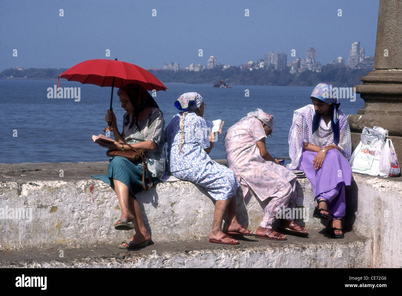 parsis Zoroastrian women praying to sea parsi gate ; marine drive on avan roz avan mahprab day ; bombay mumbai ; india Stock Photo