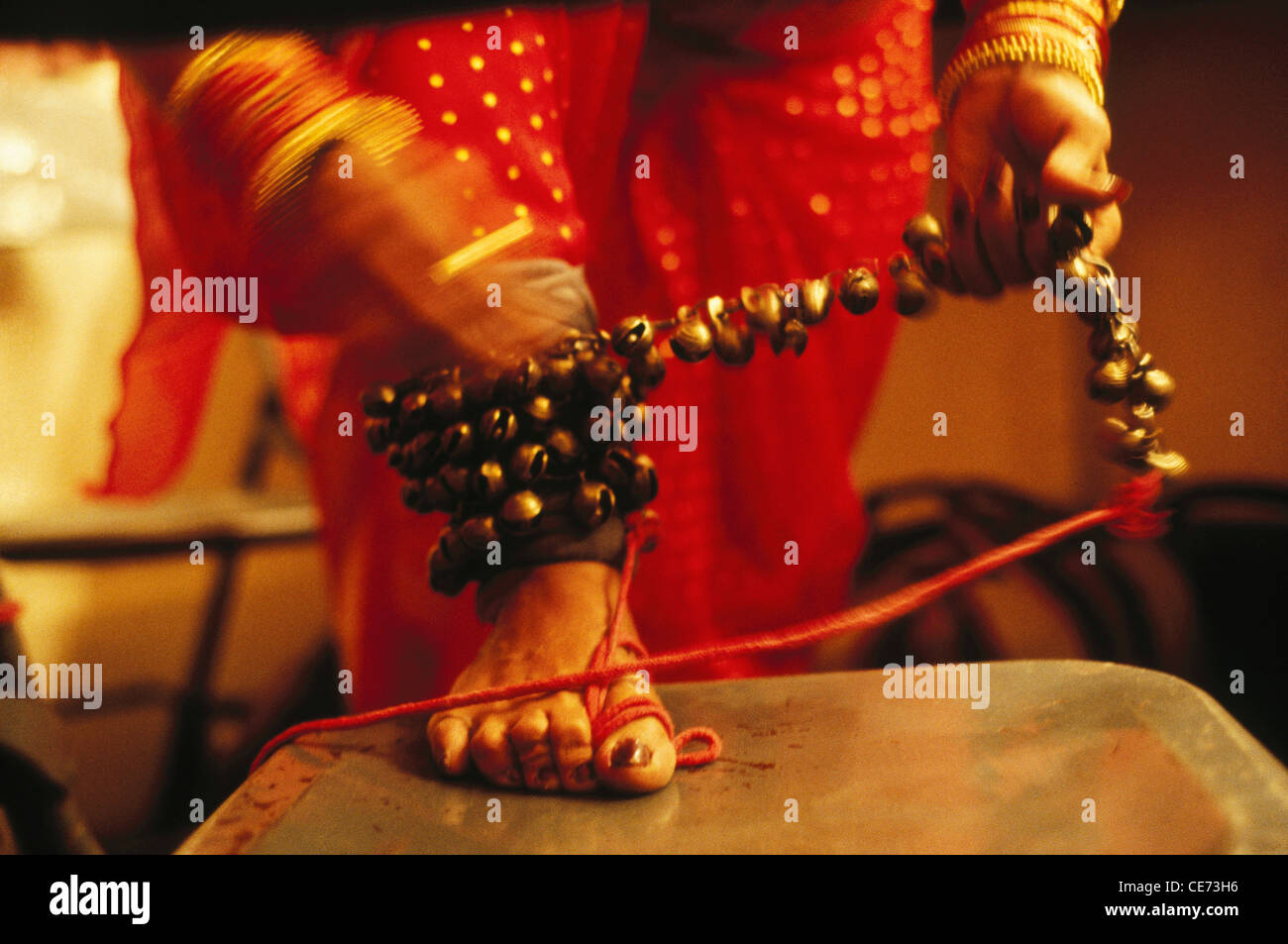 indian woman tying jingling bells ankle bell ghungroo Lavni dancer bombay mumbai maharashtra India Stock Photo