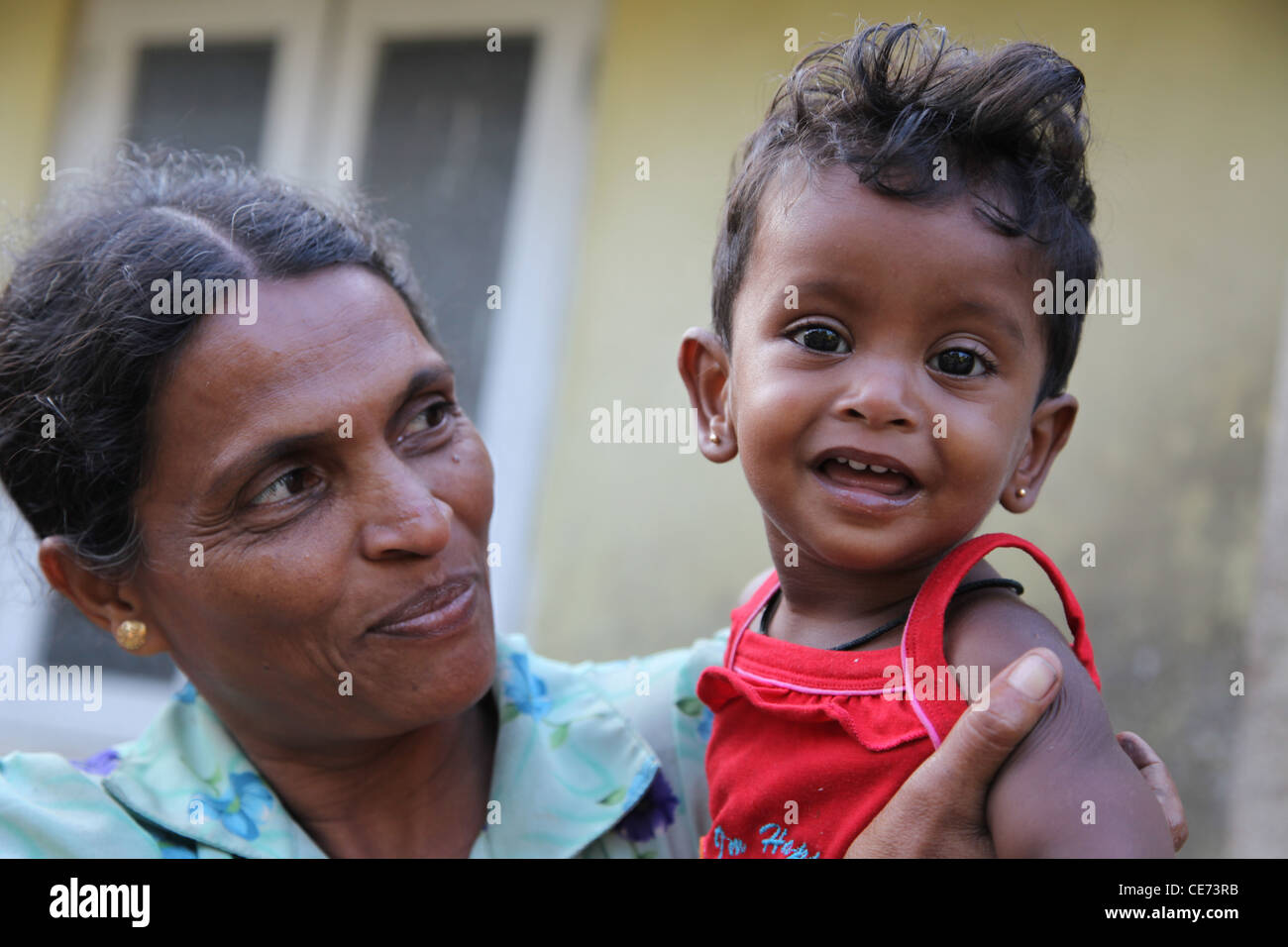 Proud mother and child. They have little money but lots of love and happiness. Captured outside their home in Sri Lanka. Stock Photo