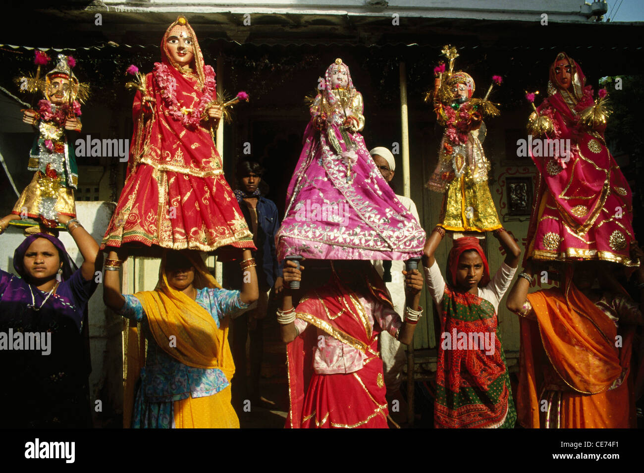 Women balancing Gangaur Goddess statue on head ; jaipur ; rajasthan ; india ; asia Stock Photo