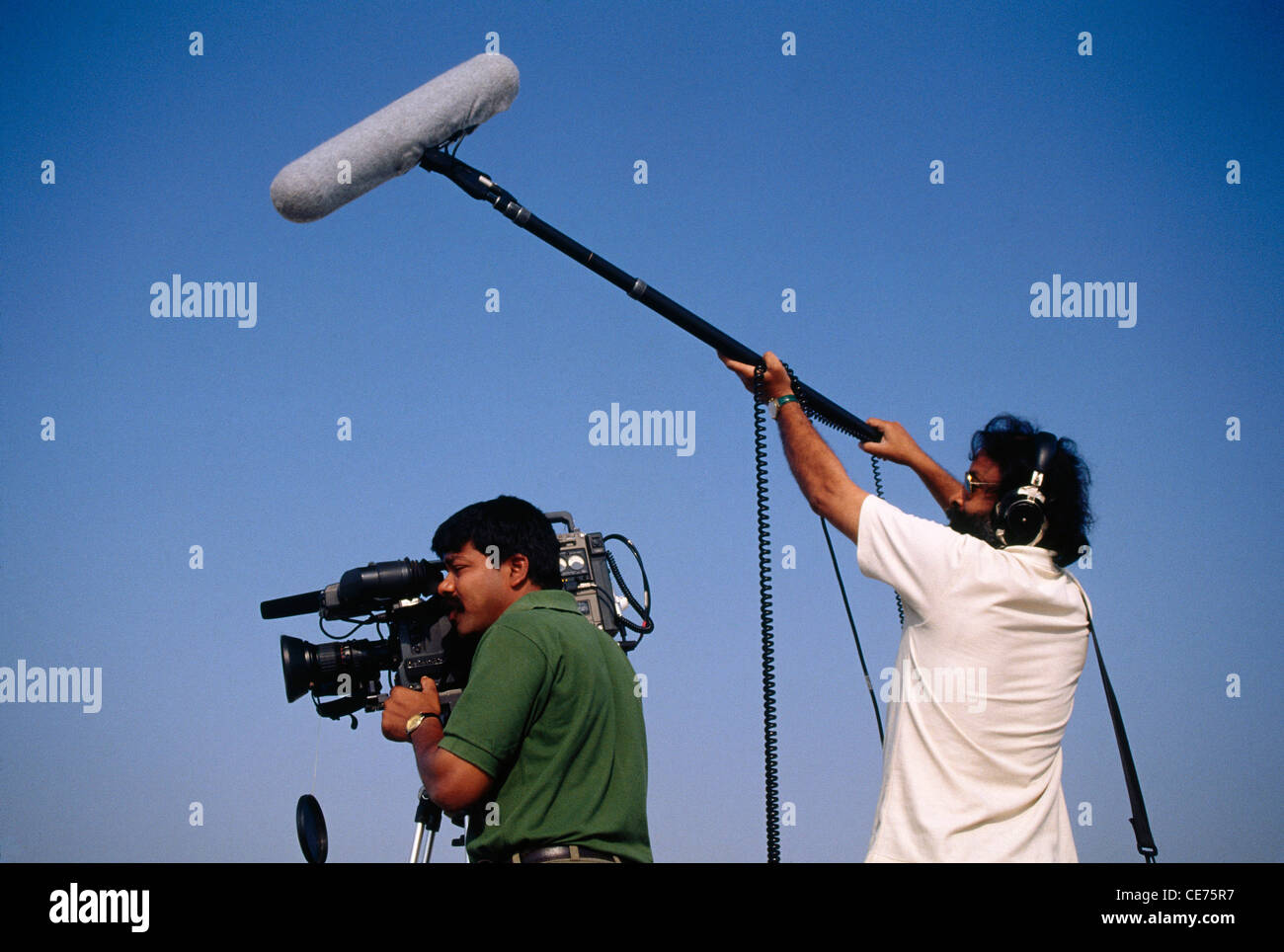 Indian TV television crew cinematographer sound recorder shooting  bombay mumbai maharashtra india Stock Photo
