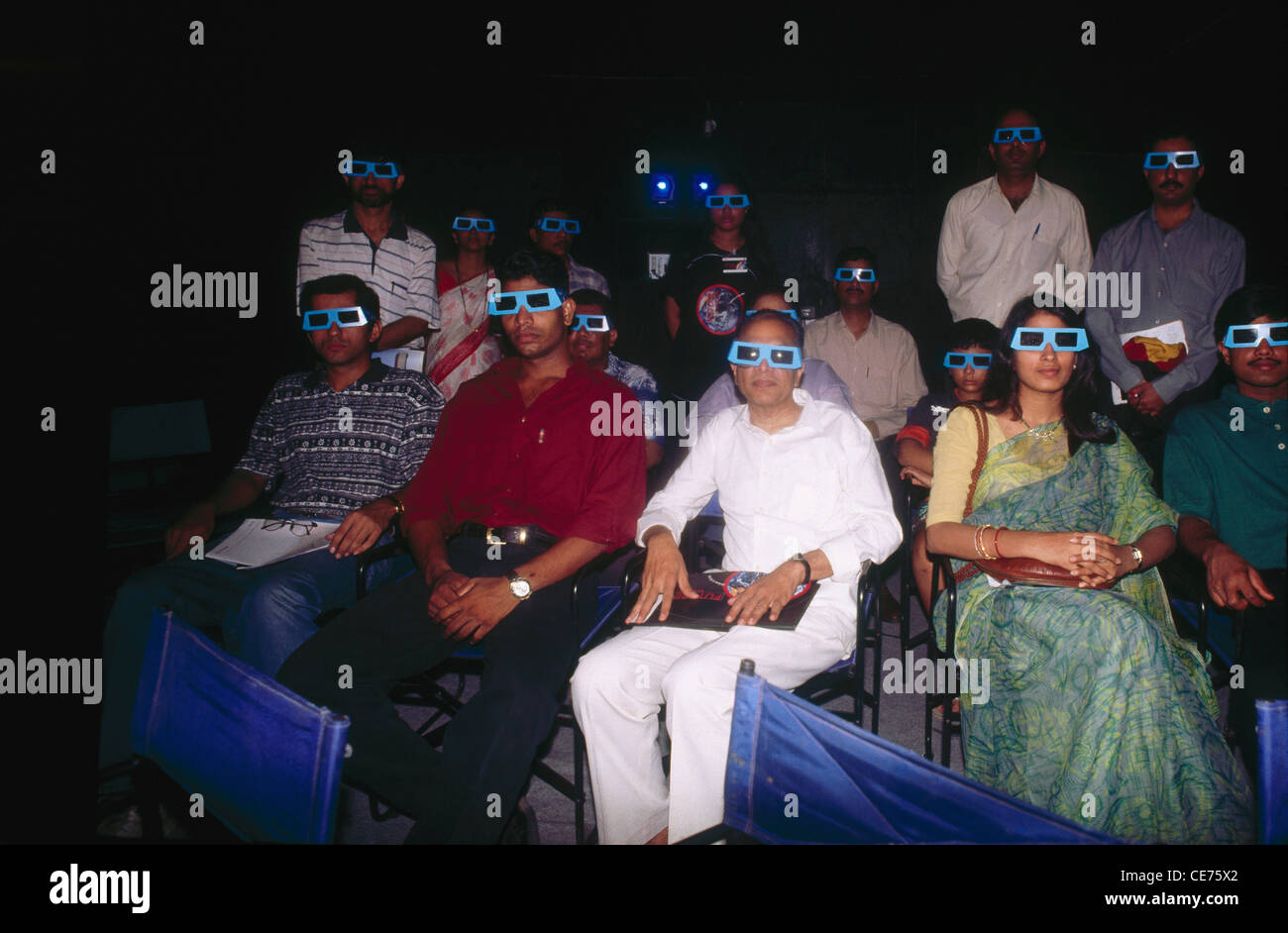 people wearing 3D glasses to see 3D film ; bombay ; mumbai ;  maharashtra ; india ; asia Stock Photo