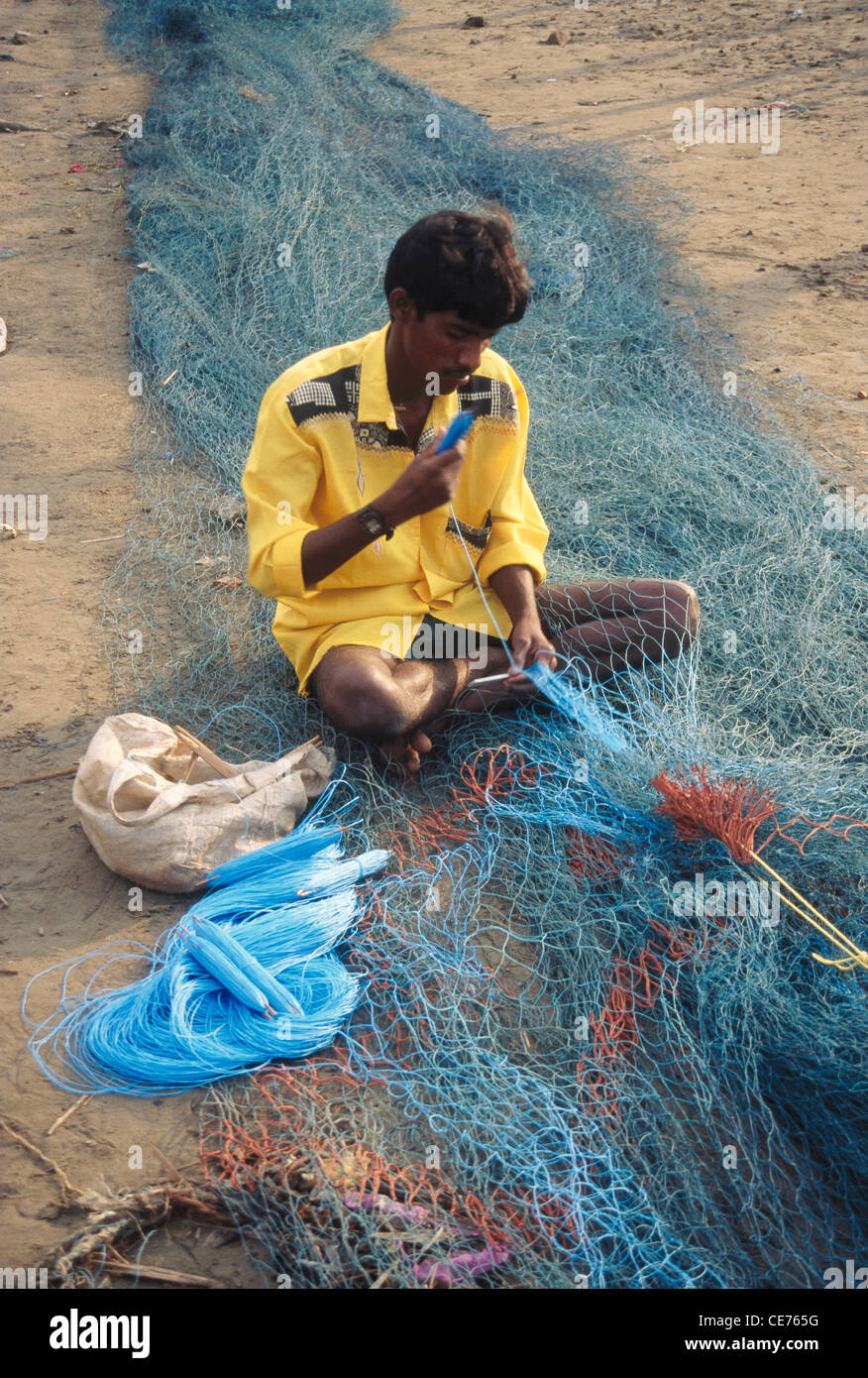 NGS 84702 fisherman weaving net ; madh island ; bombay mumbai ; maharashtra ; india Stock