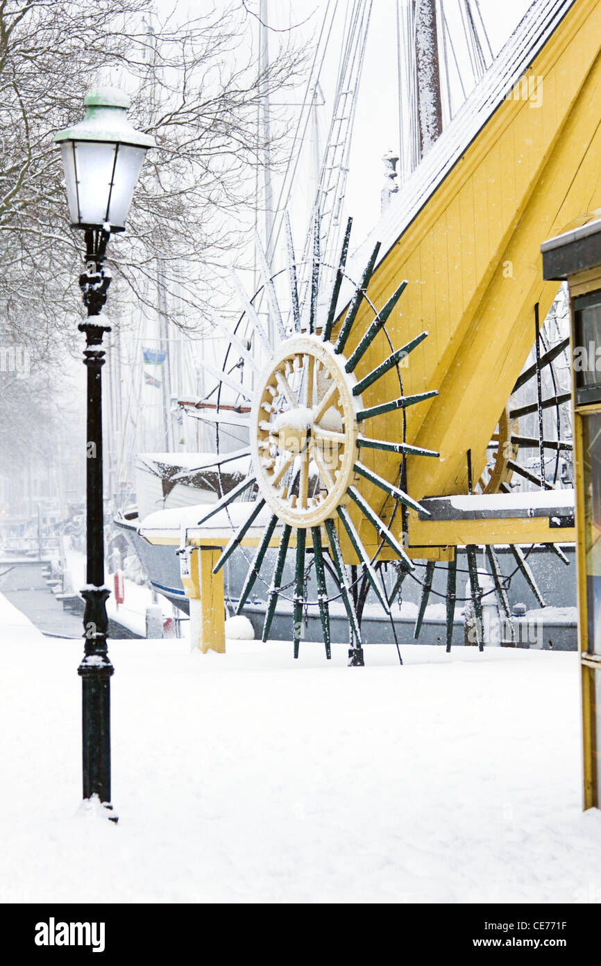 Snow in the city - old wintery harbor - it is snowing Stock Photo
