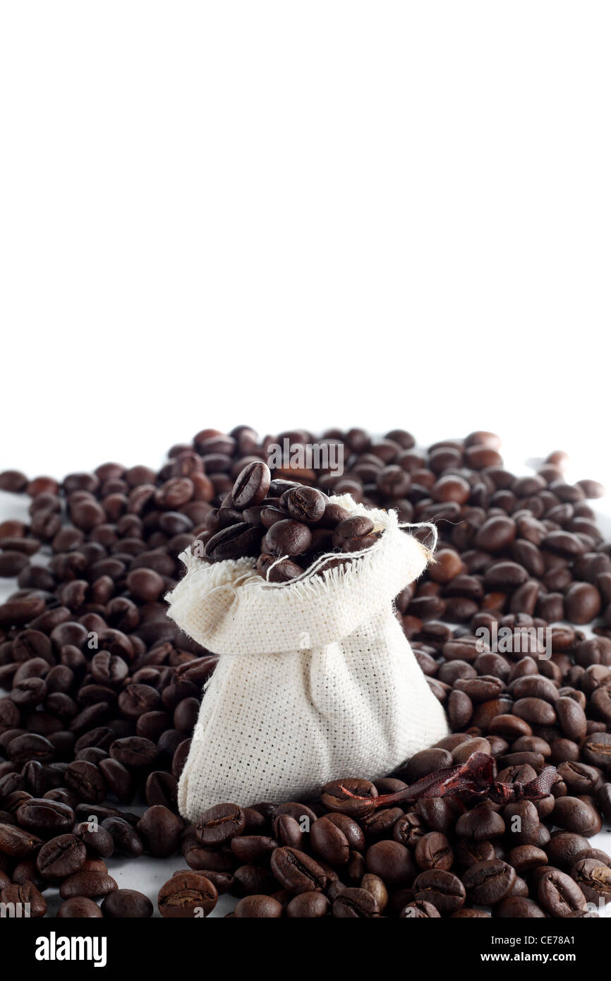 Coffee beans in a sack with a lot of beans around it Stock Photo - Alamy