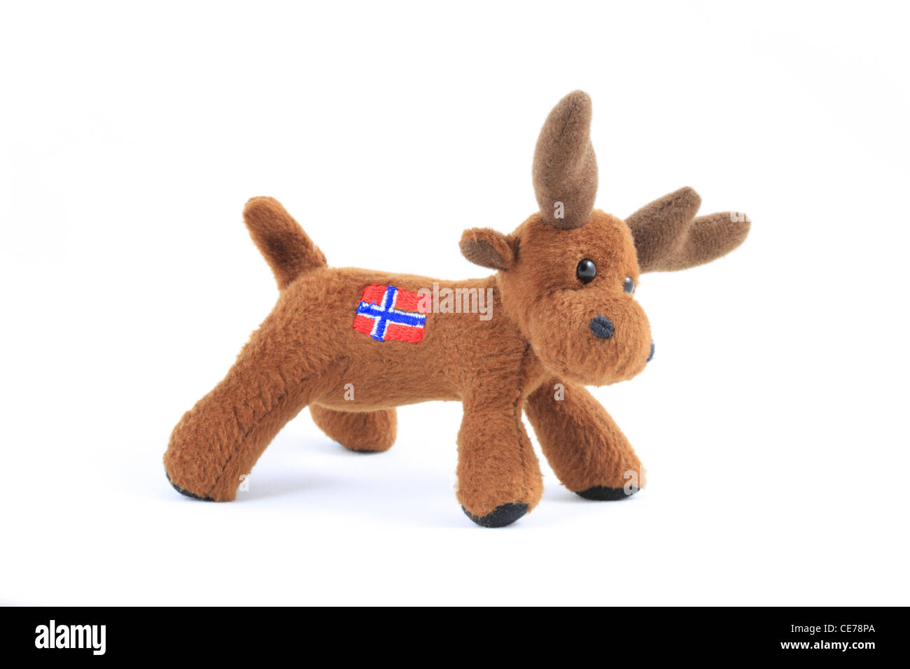 A cut out soft toy moose elk with a Norwegian flag of Norway on its back photographed against a white background. Stock Photo