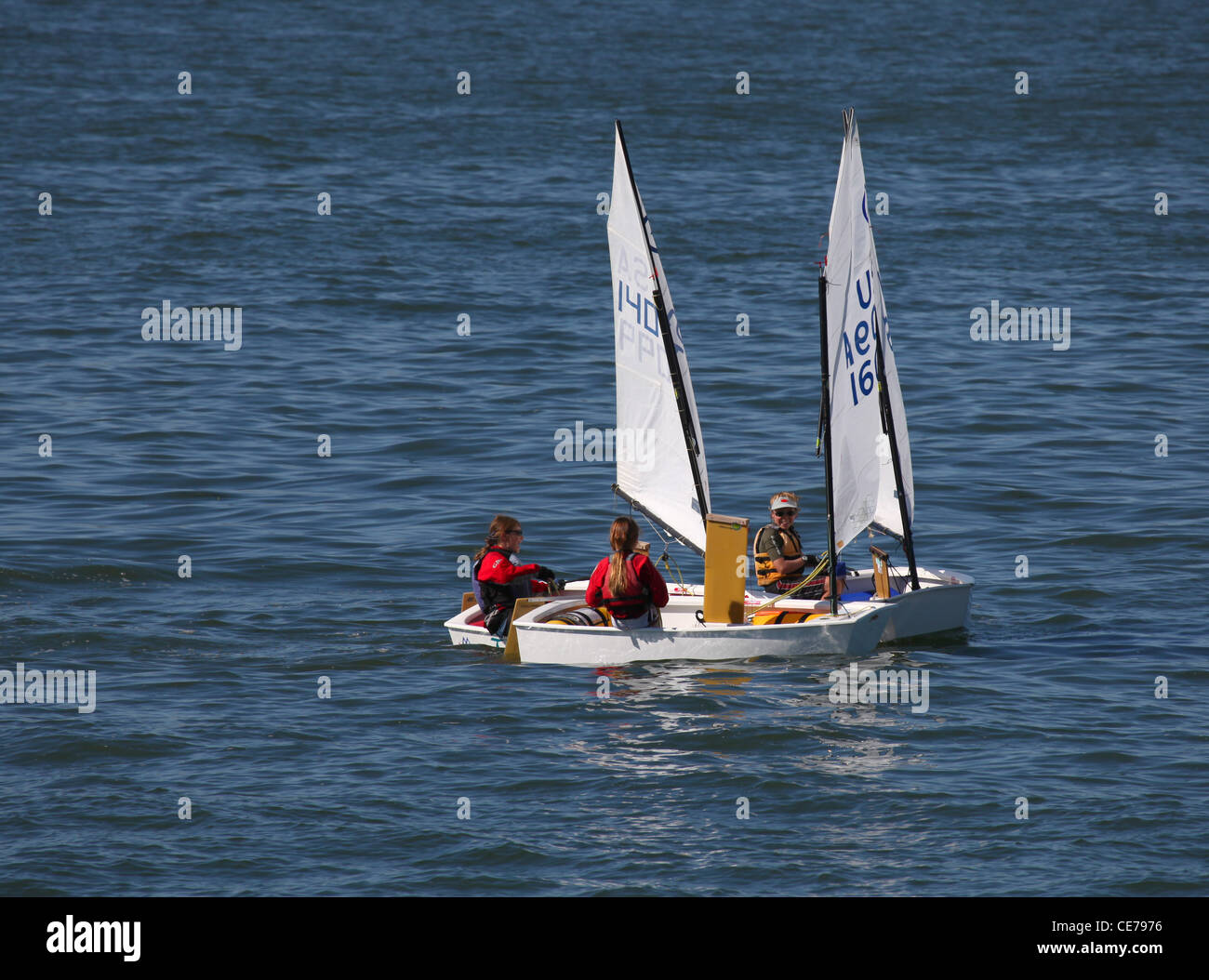 Three Optimist Class sailing dinghies in San Francisco Bay off Sausalito Stock Photo
