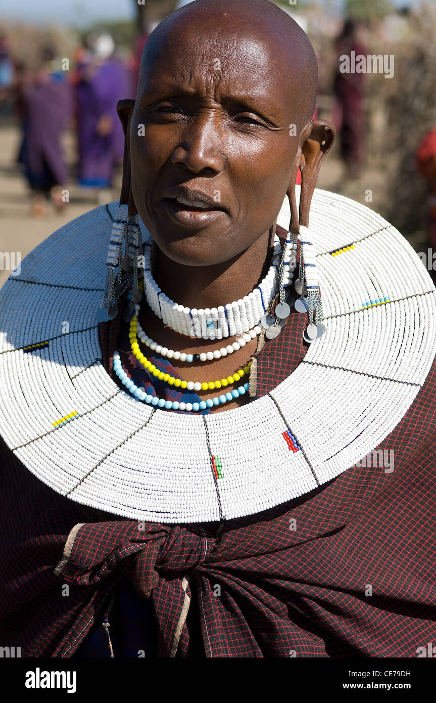 A Masai woman in Tanzania with the traditional shaved head and split ears,  large ornate collar, bead necklaces and earrings Stock Photo - Alamy