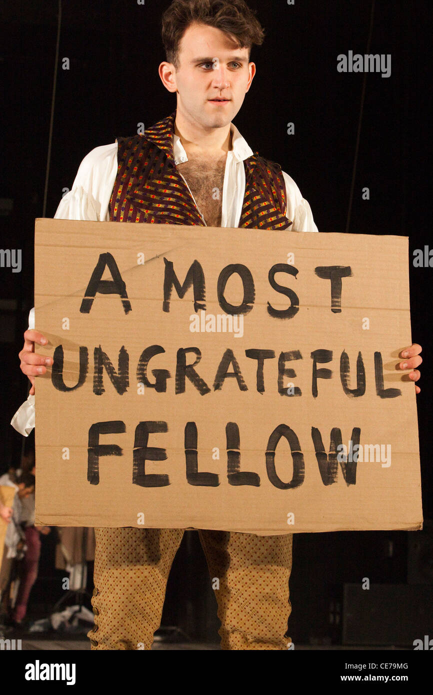 The School for Scandal opens at the Barbican Theatre. Actor holding up a "most ungrateful fellow" sign Stock Photo