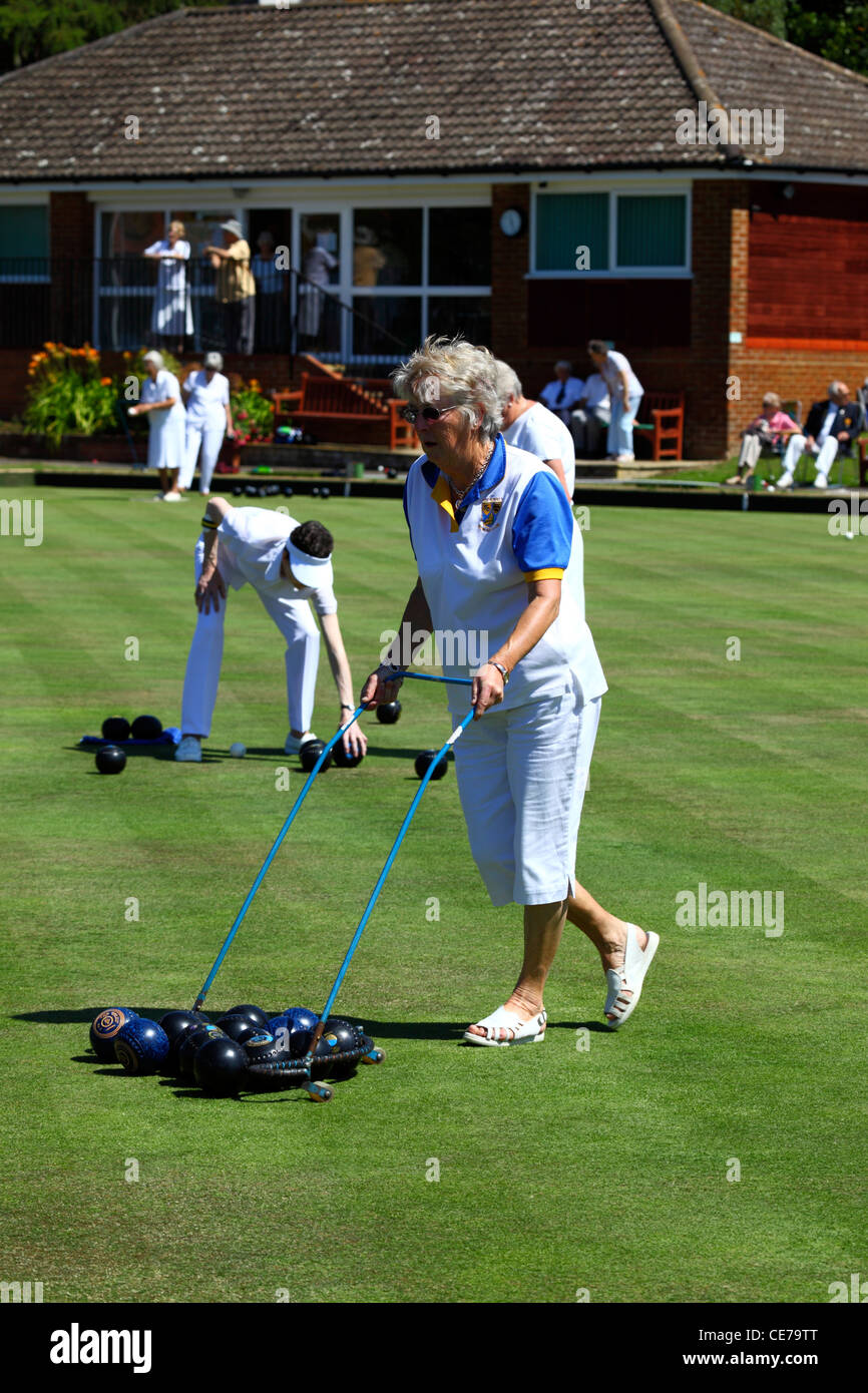 Lady collecting bowls with trolley after a game , Southborough Common , Tunbridge Wells , Kent , England Stock Photo