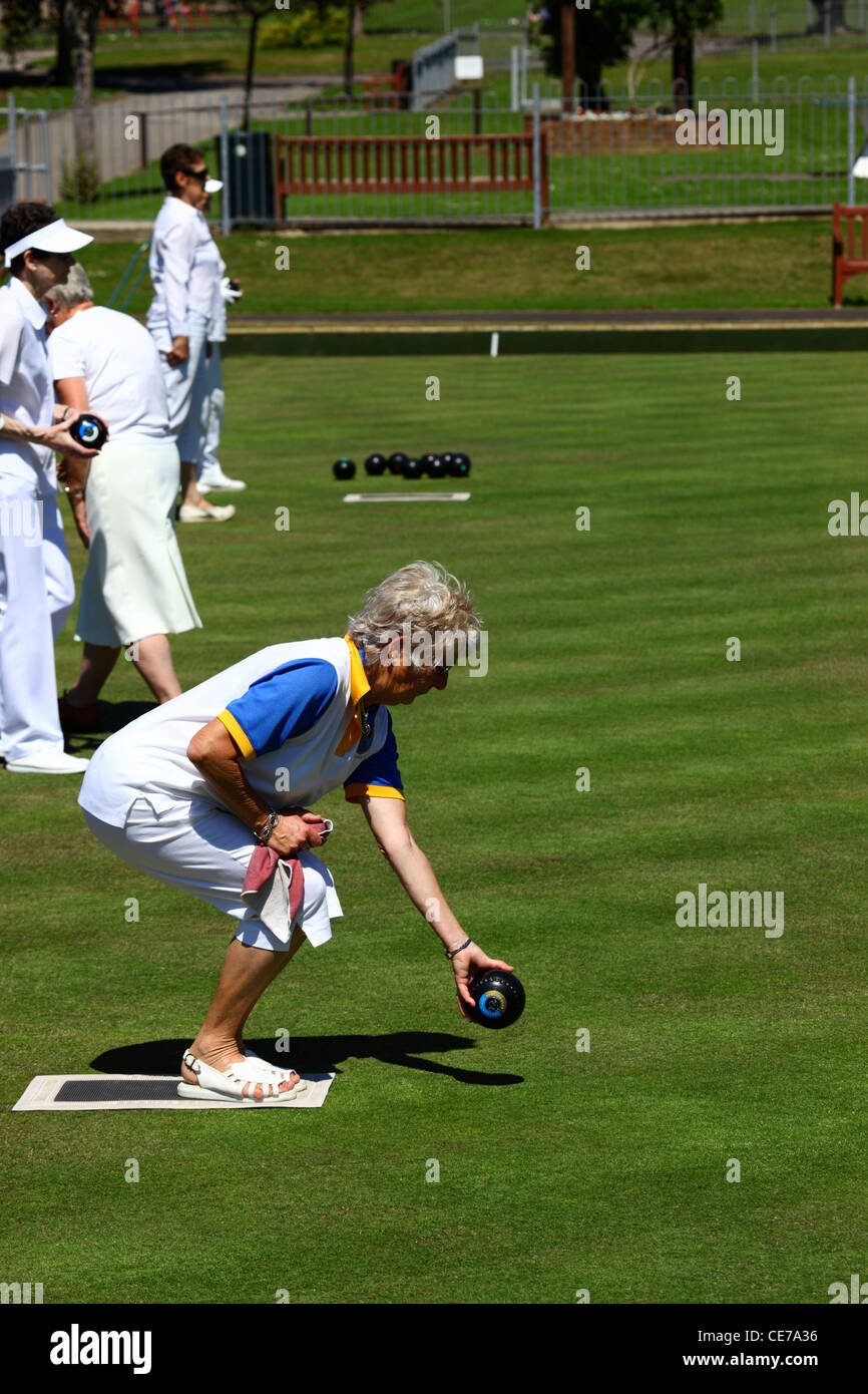 Lady about to bowl during a game of bowls , Southborough Common , Tunbridge Wells , Kent , England Stock Photo