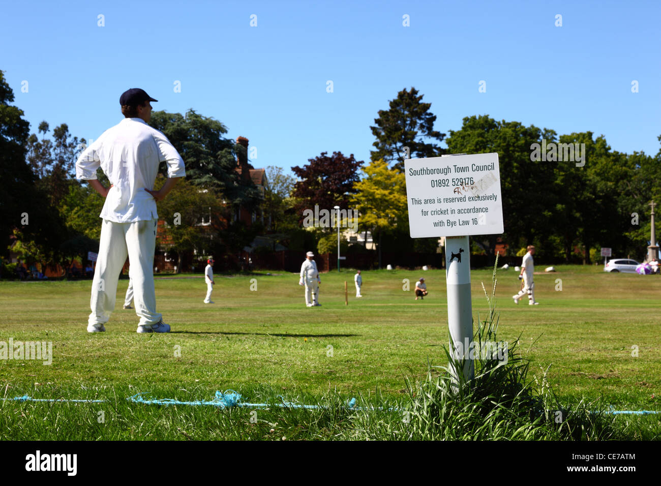 Local Bye Law sign next to pitch, cricket match in progress , Southborough Common , near Tunbridge Wells , Kent , England Stock Photo