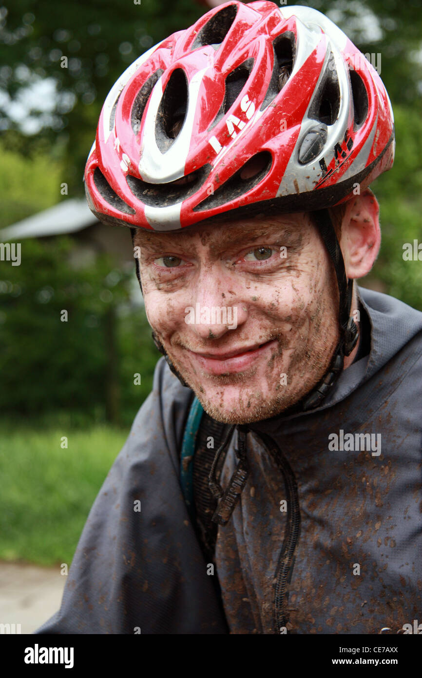 muddy and smily mountain biker face Stock Photo