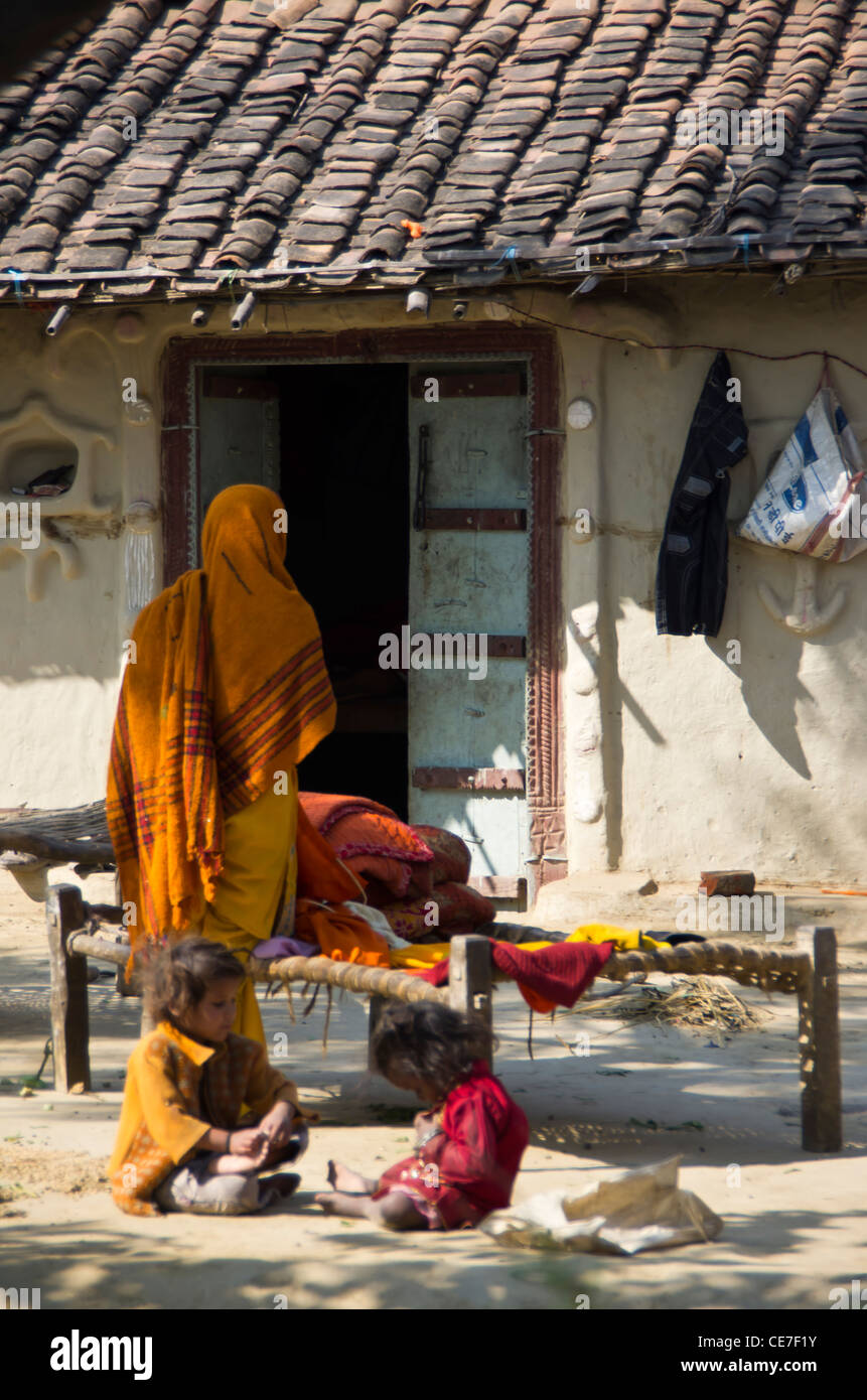 family playing at home in an Indian village with a hut in background Stock  Photo - Alamy
