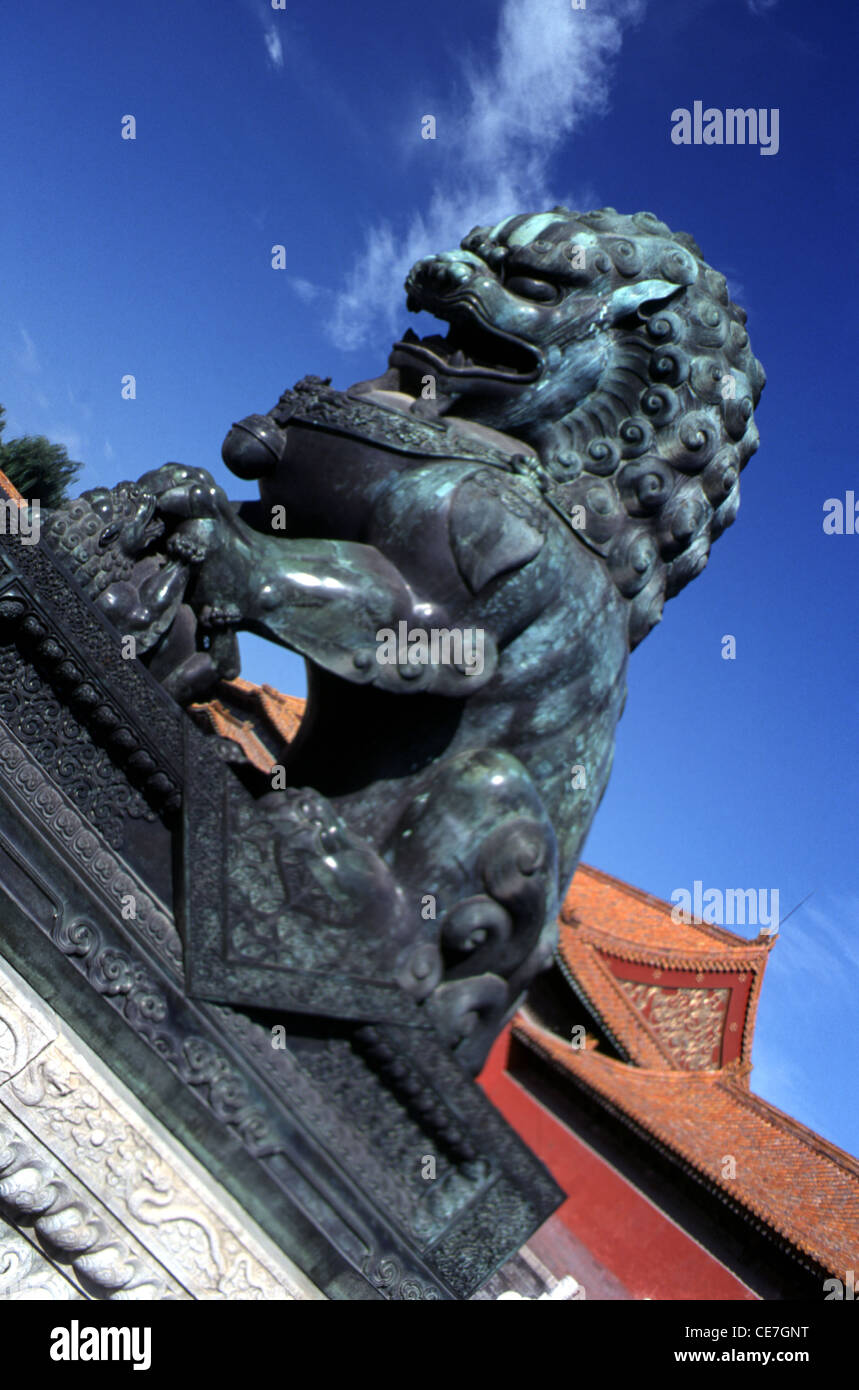 A bronze lion guarding the western approach to the Gate of Supreme Harmony in the historic Forbidden City that was the Chinese imperial palace from the Ming dynasty to the end of the Qing dynasty located at the center of Beijing capital of China Stock Photo
