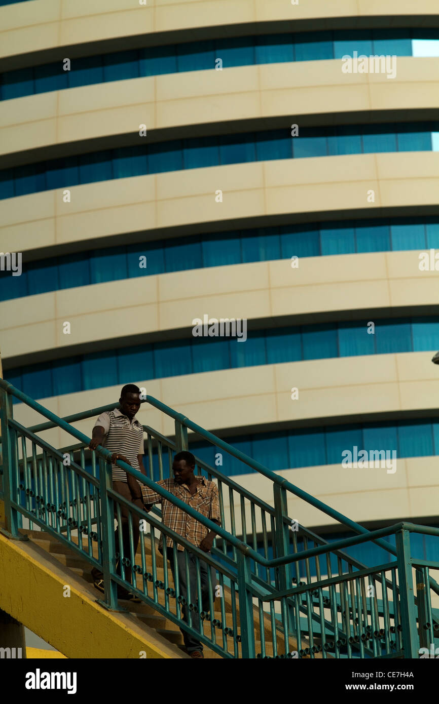 People crossing overpass in front of Boji Al-Fateh Hotel Khartoum Sudan Stock Photo