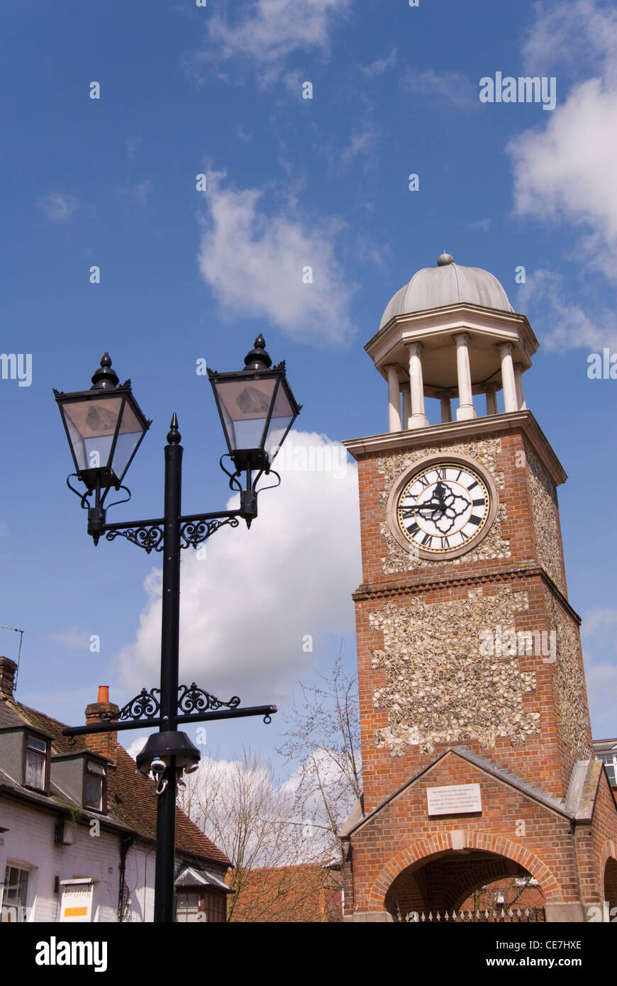 Chesham - Bucks. Town clock tower and decorative ironwork street lamps - viewed against blue sky Stock Photo