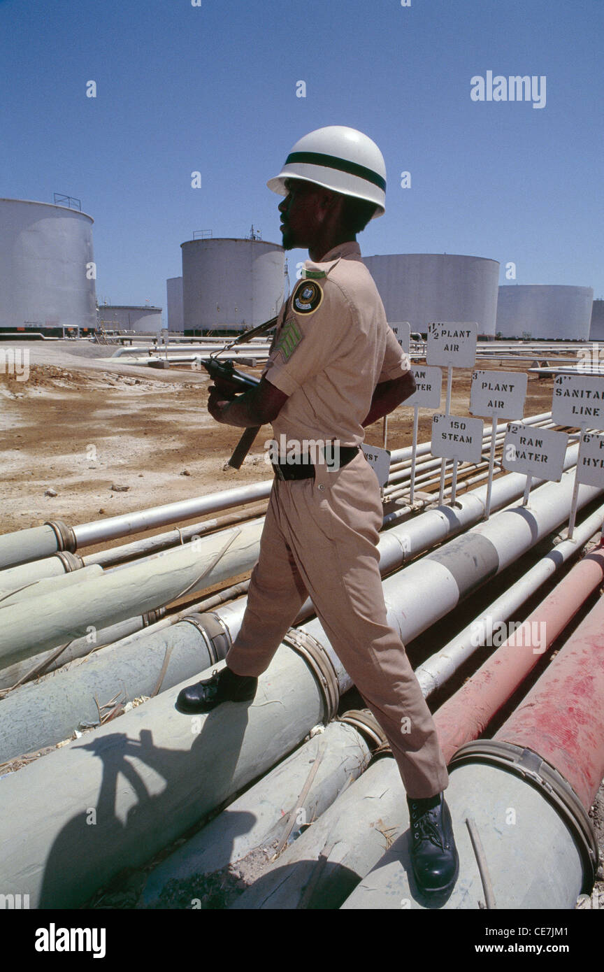 A Saudi soldier guards the largest oil refinery in the world, located at Ras Tanura, on the east coast of Saudi Arabia. Stock Photo