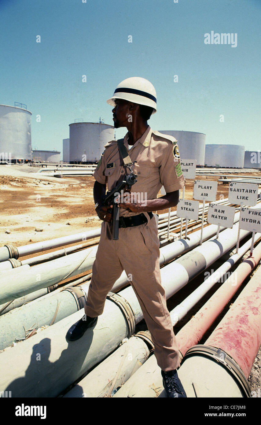 A Saudi soldier guards the largest oil refinery in the world, located at Ras Tanura, on the east coast of Saudi Arabia. Stock Photo