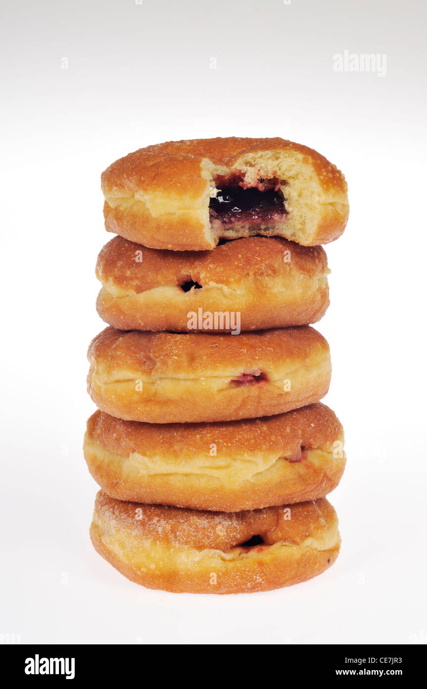 Stack of jelly donuts with bite taken out of top donut on white background cutout. Stock Photo