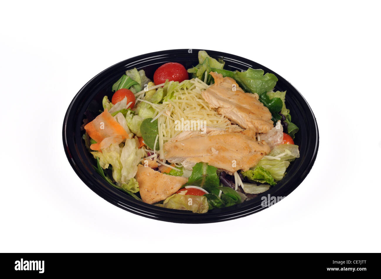 McDonalds grilled chicken caesar salad in black plastic takeaway container on white background cutout. Stock Photo