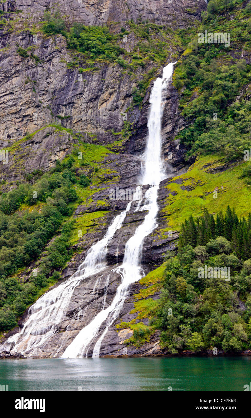 Waterfall discharging into Geiranger Fjord, Hellesylt, Norway Stock Photo