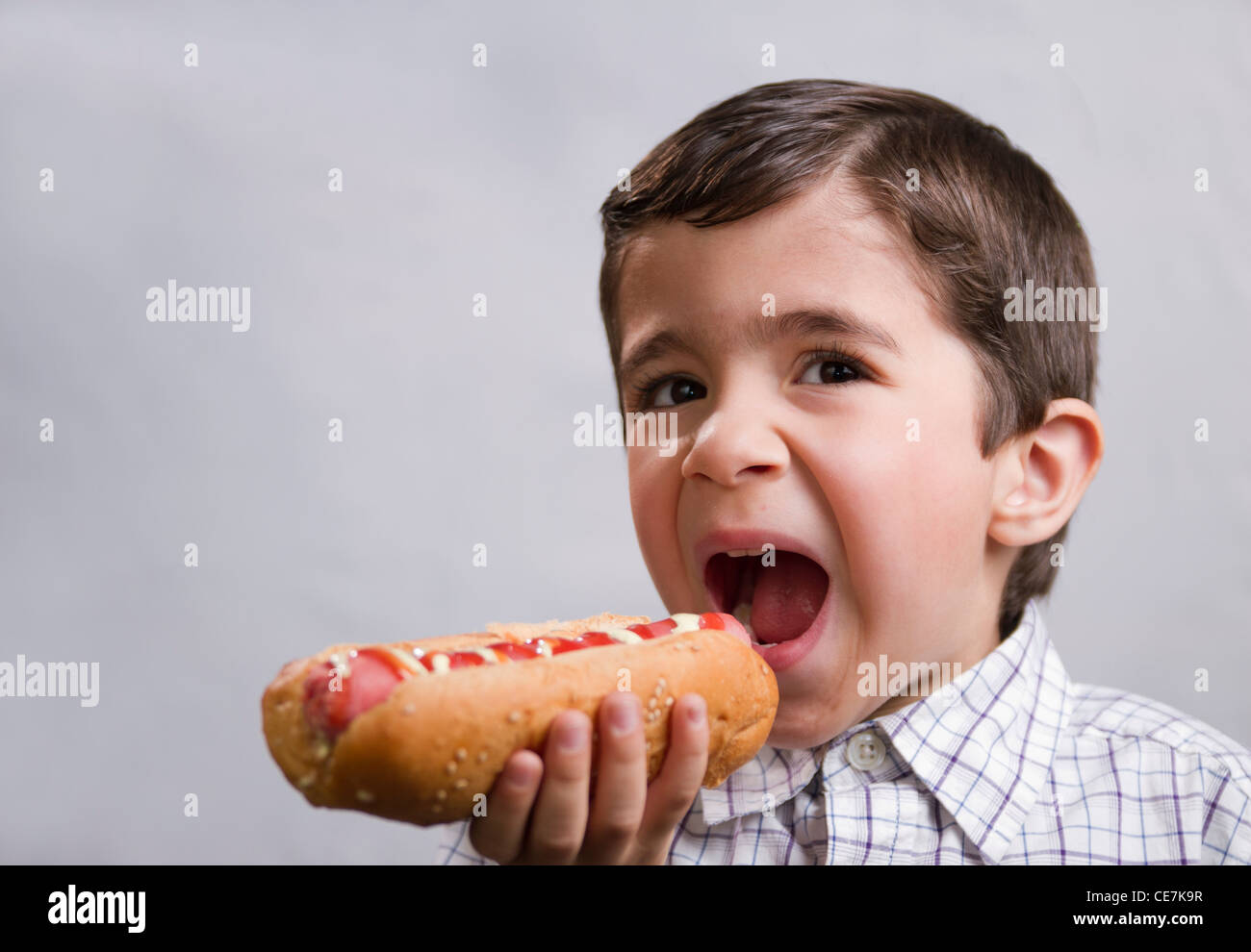 boy eating hotdog Stock Photo