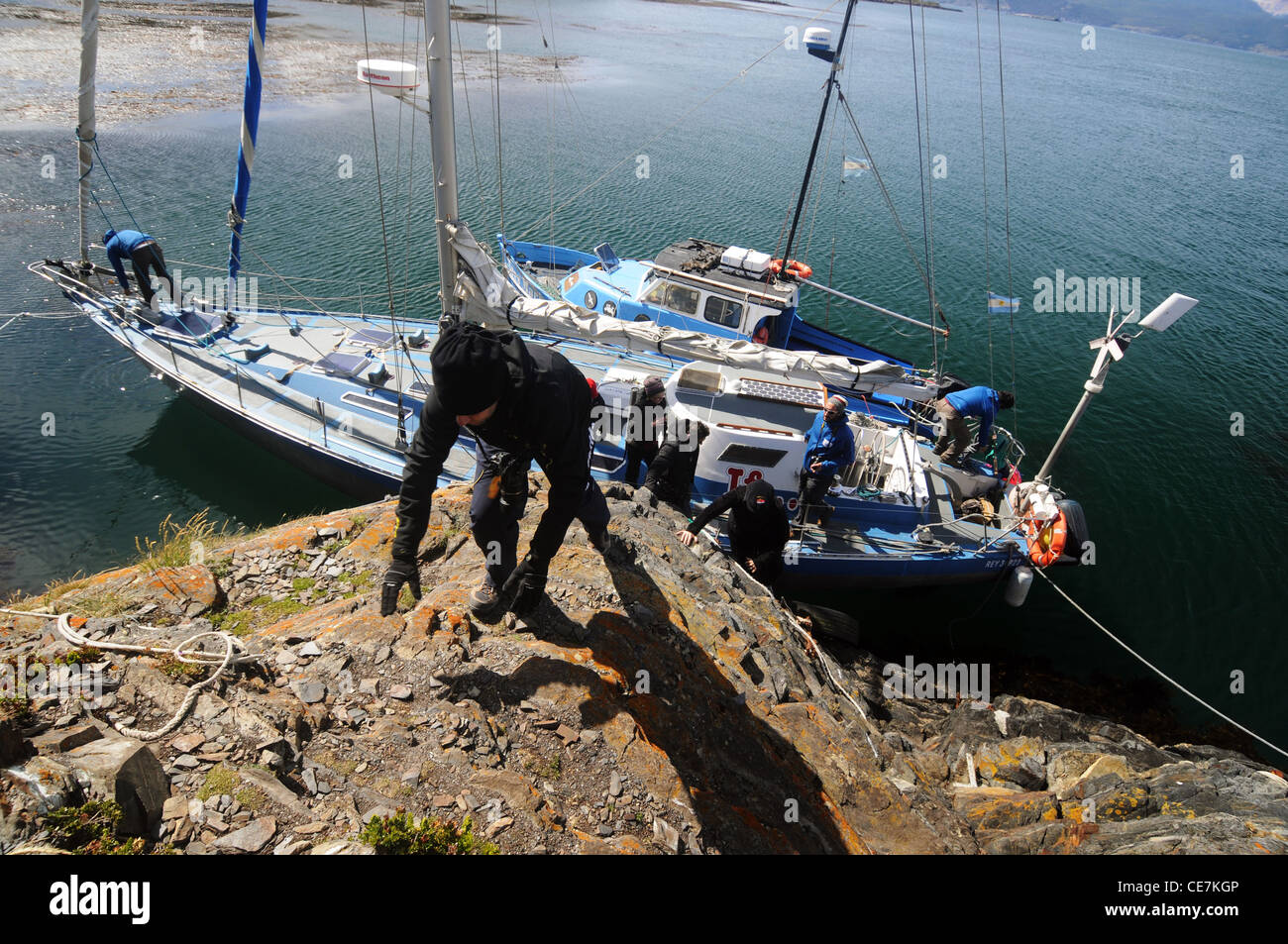 People climbing ashore from yacht onto H Island, Beagle Channel, near Ushuaia, Tierra del Fuego, Argentina. No PR or MR Stock Photo