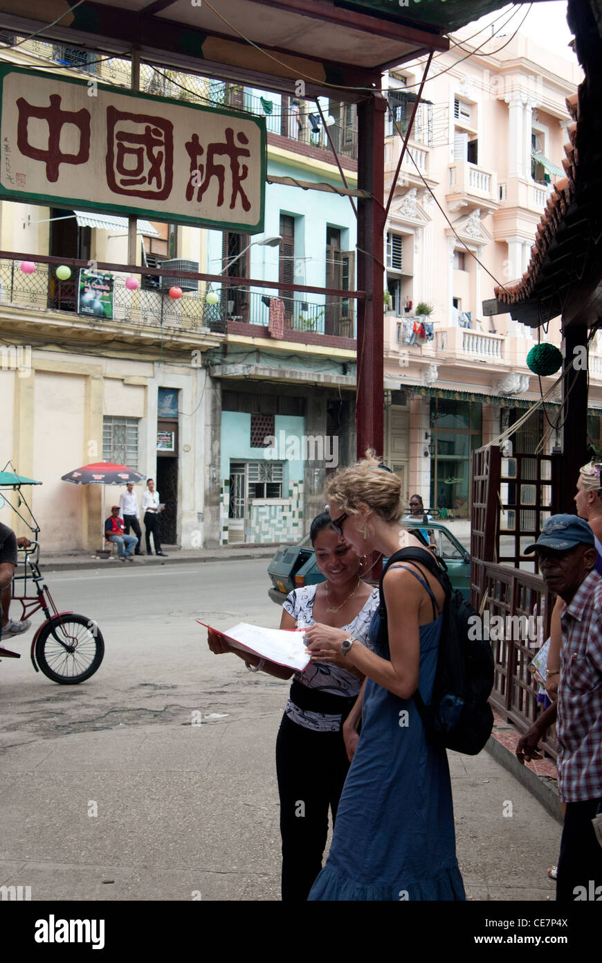 Tourist is looking a the menu with a waitress in China Town, Havana, Cuba Stock Photo